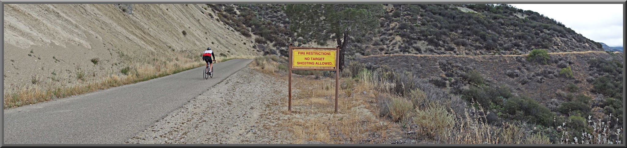 Climbing Figueroa Road by bike - Los Padres National Forest sign and road.