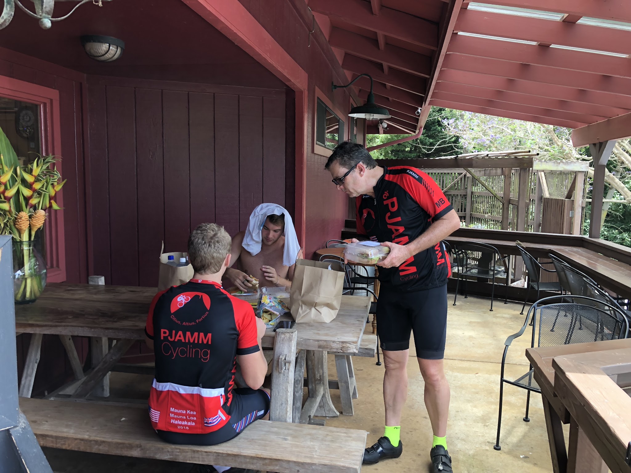 Bike climb Haleakala Volcano - PJAMM cyclists eating lunch Kula Market