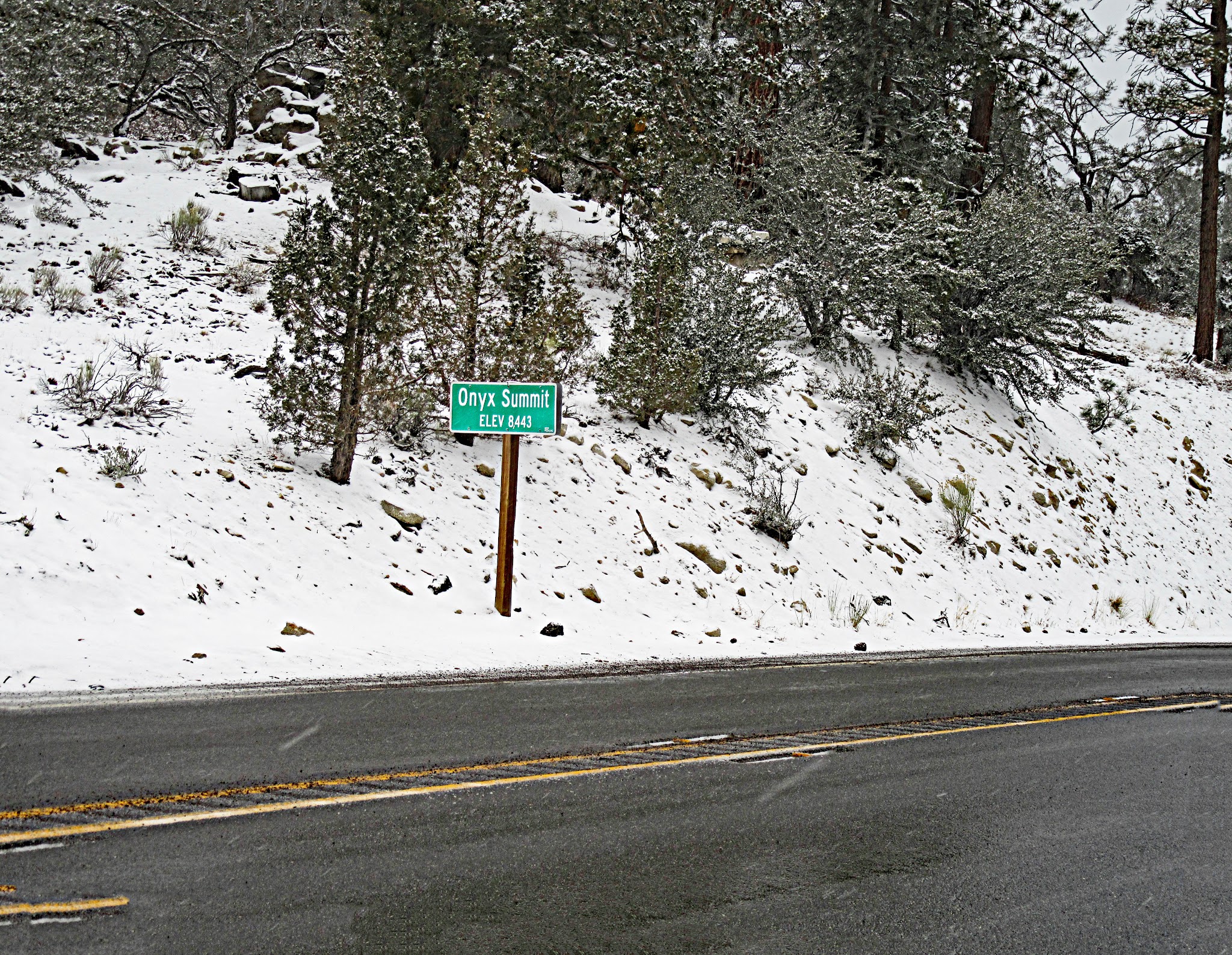Onyx Summit bike ride - summit sign, snow