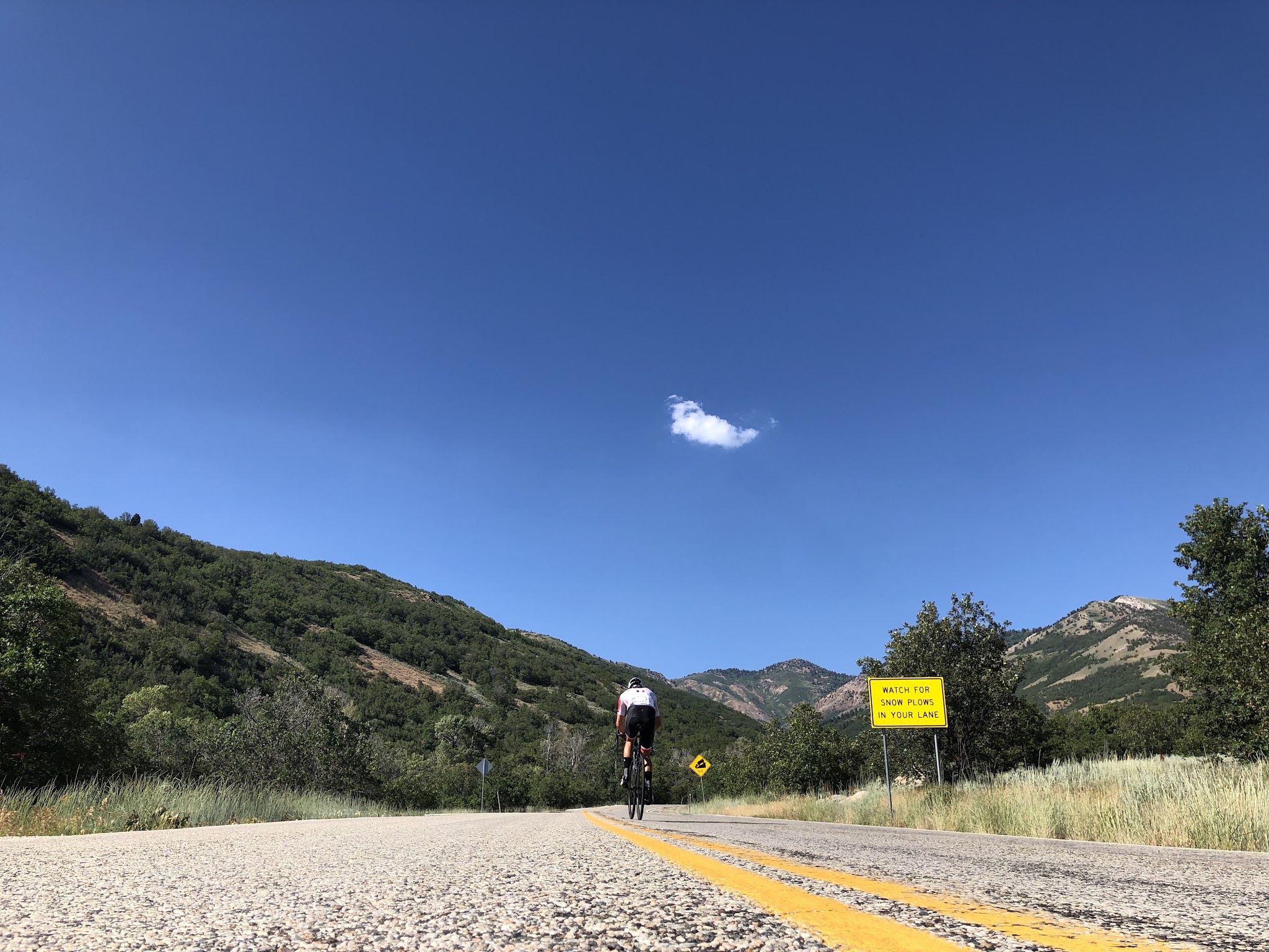 Cyclist passing roadway warning sign