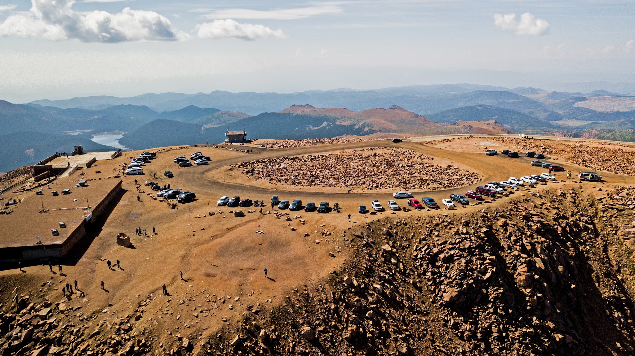 Cycling Pikes Peak - aerial drone photo of summit - parking lot and mountains sky clouds