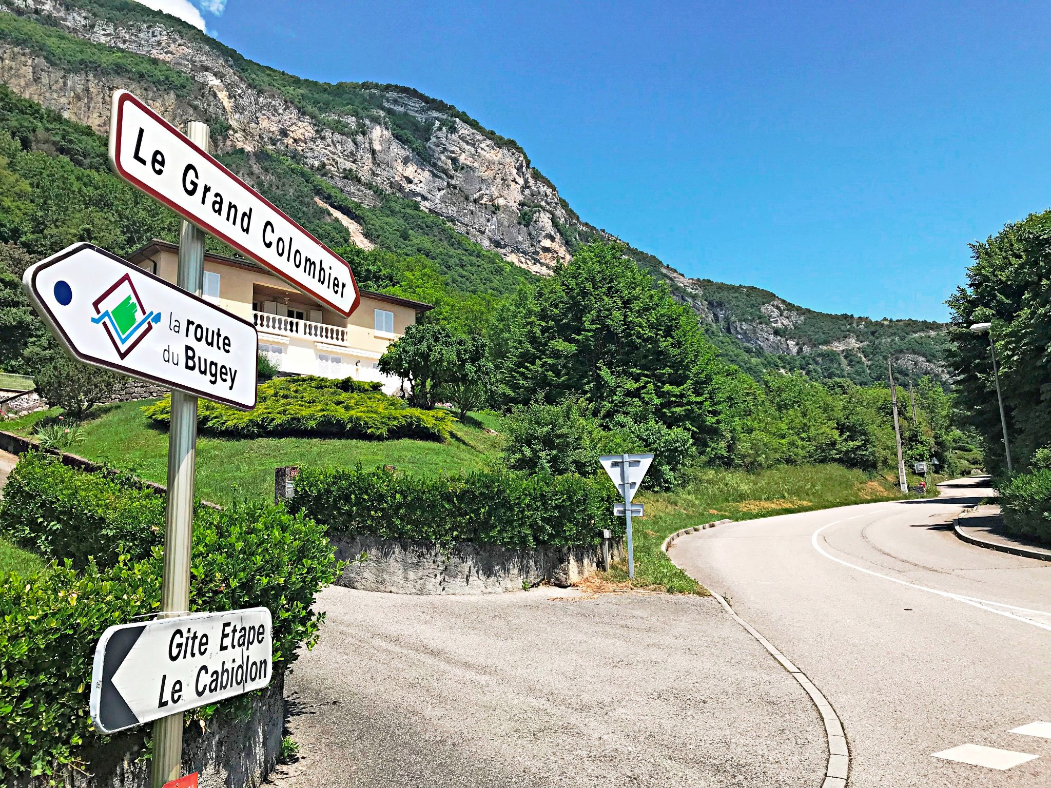 roadsigns read "Le Grand Colombier," "la route de Bugey," and Gite Etape le Cabiolon"