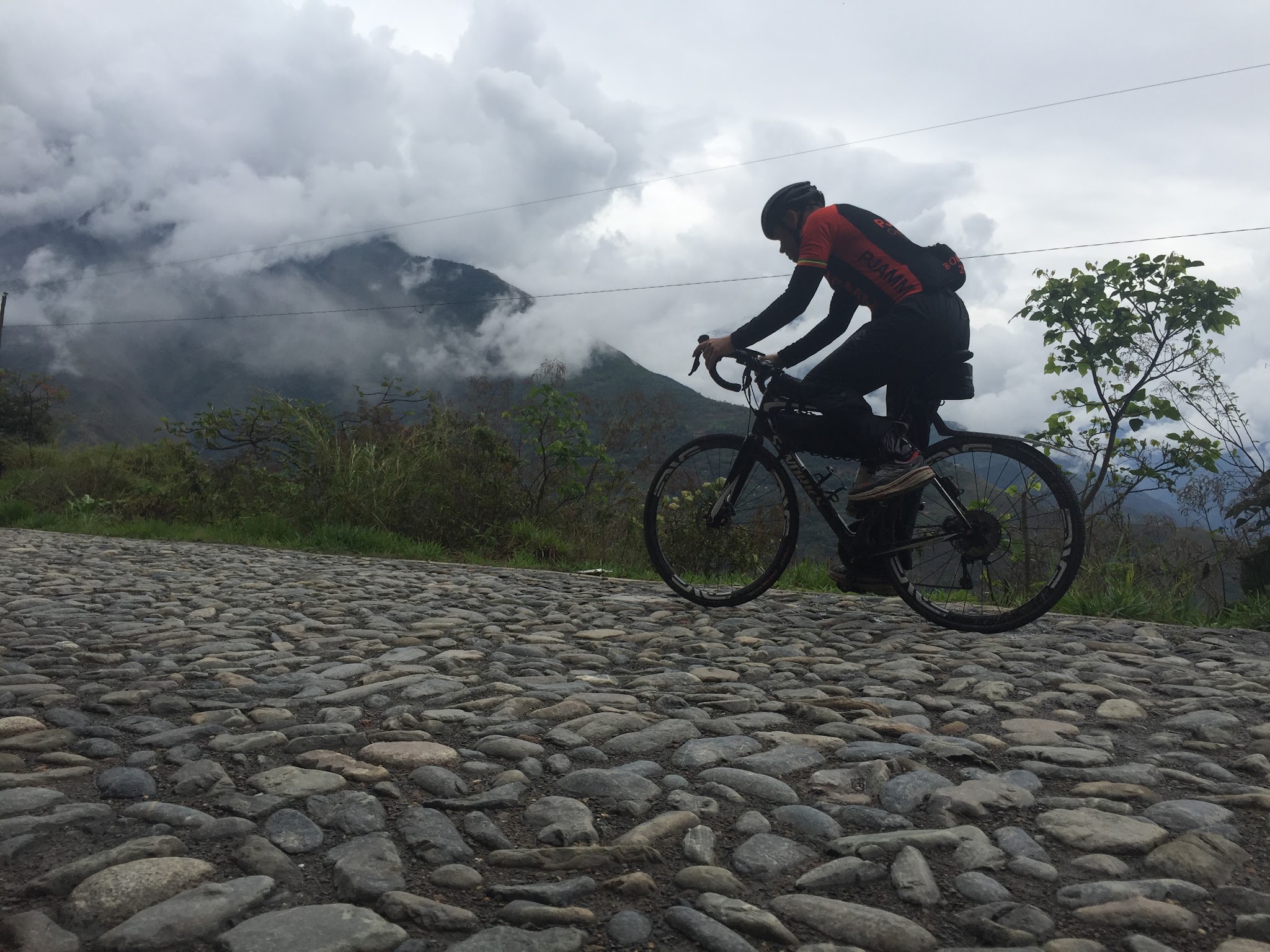 Cyclists riding on cobbles on North Yungas Road near Coroico, Bolivia