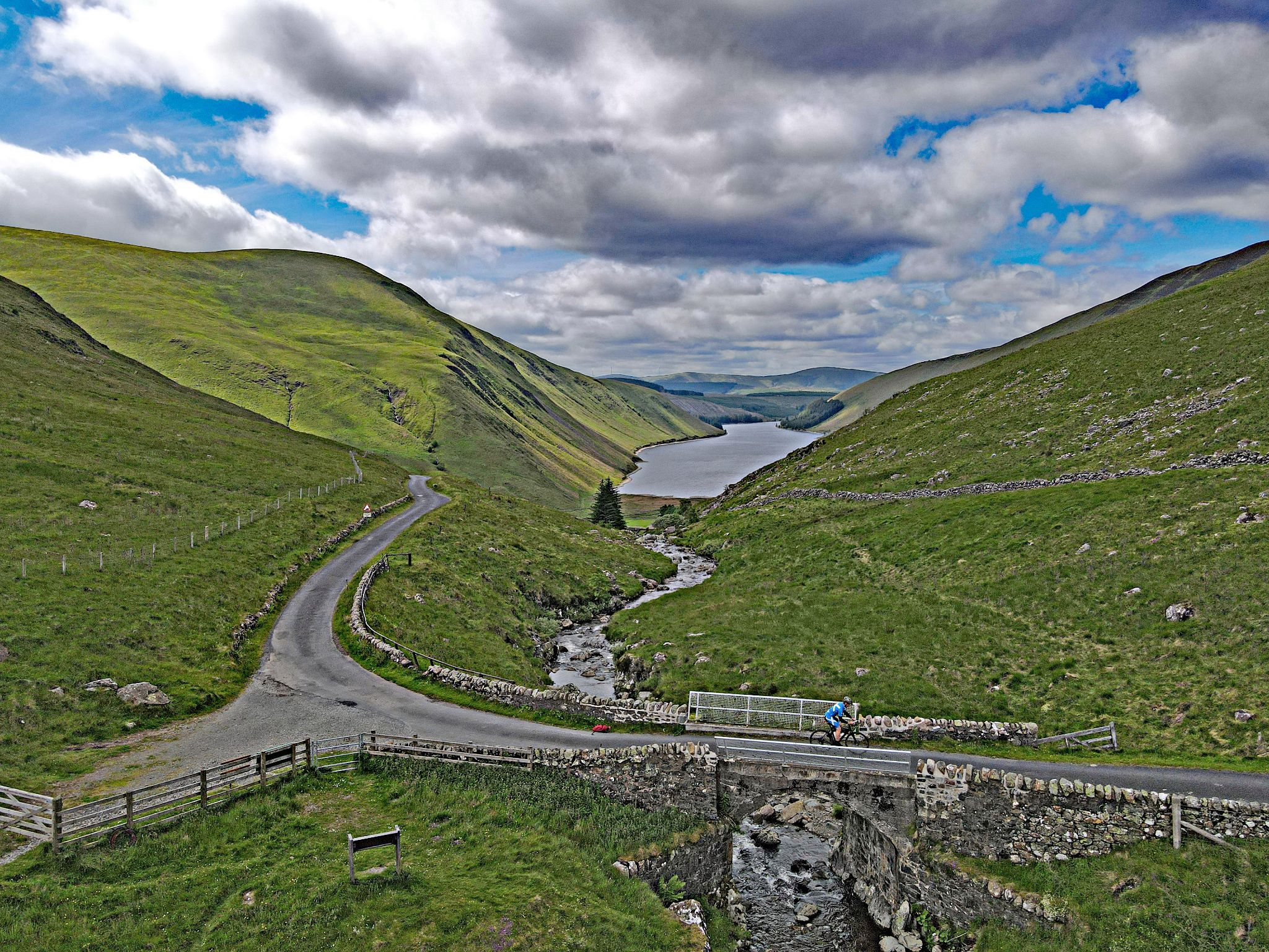 aerial drone view shows PJAMM Cyclist crossing over Talla Water
