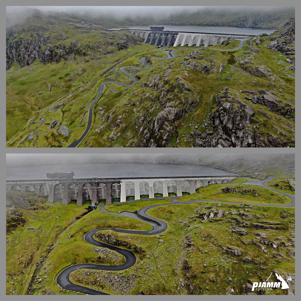 aerial drone view shows roadway snaking up the green hillside to Stwlan Dam