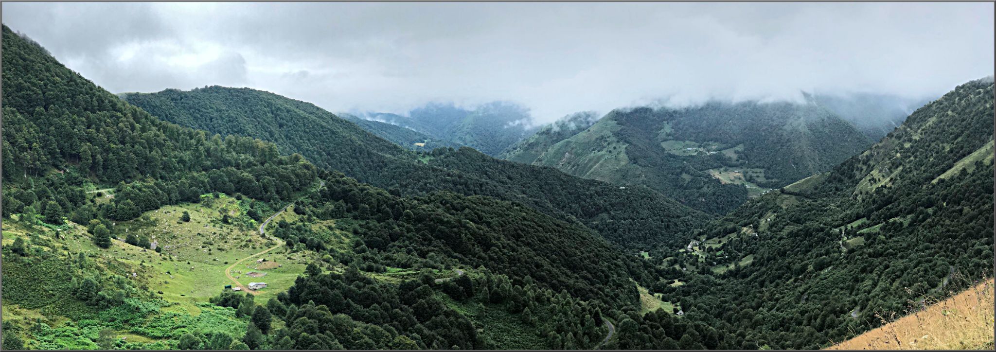 Panoramic view looking down on the ravine that is climbed up from Ferrieres; lush green mountains