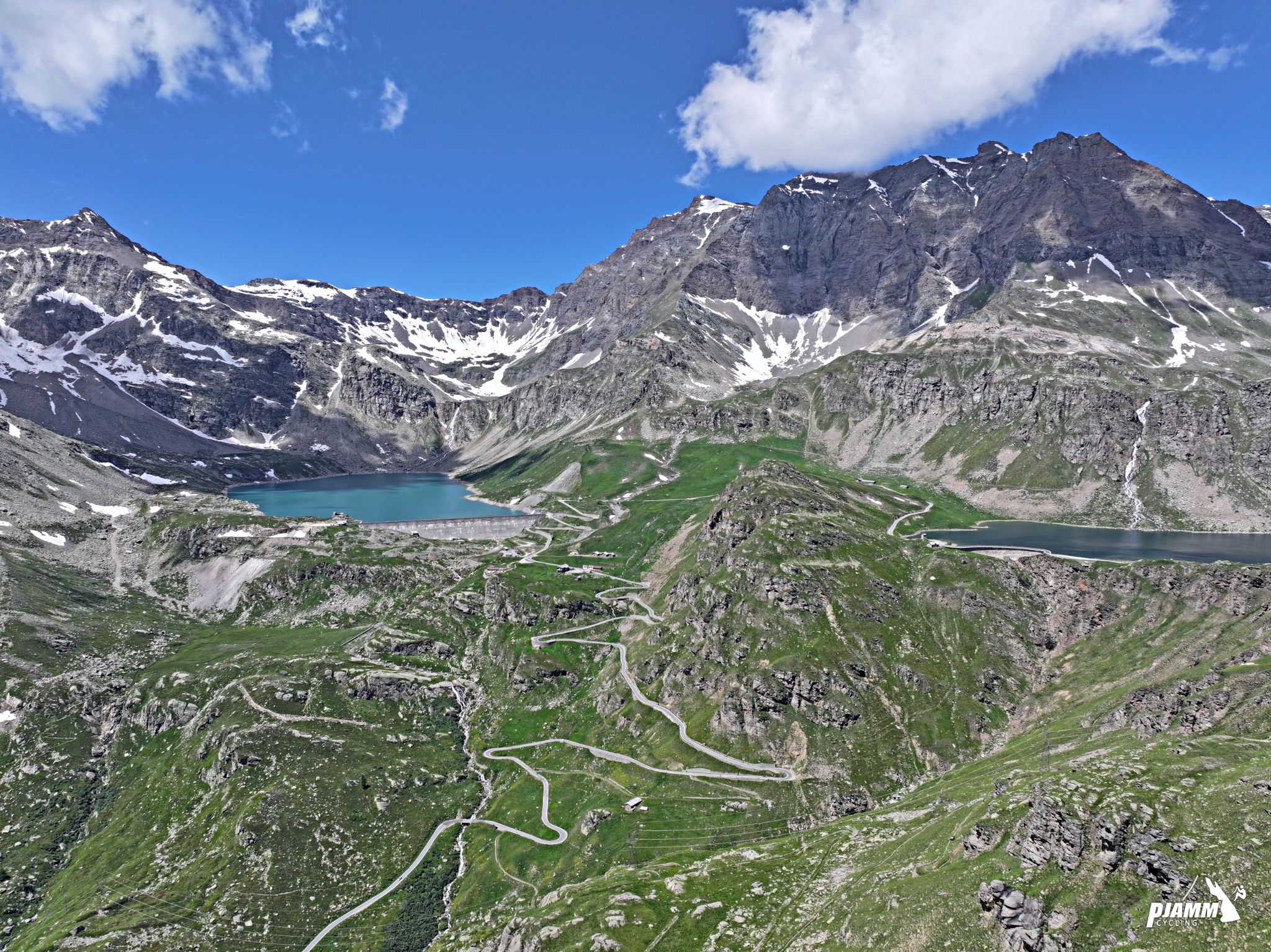 Cycling Colle de Nivolet, Italy - view looking out to switchbacks leading up to Lago Serru and Torino Dam