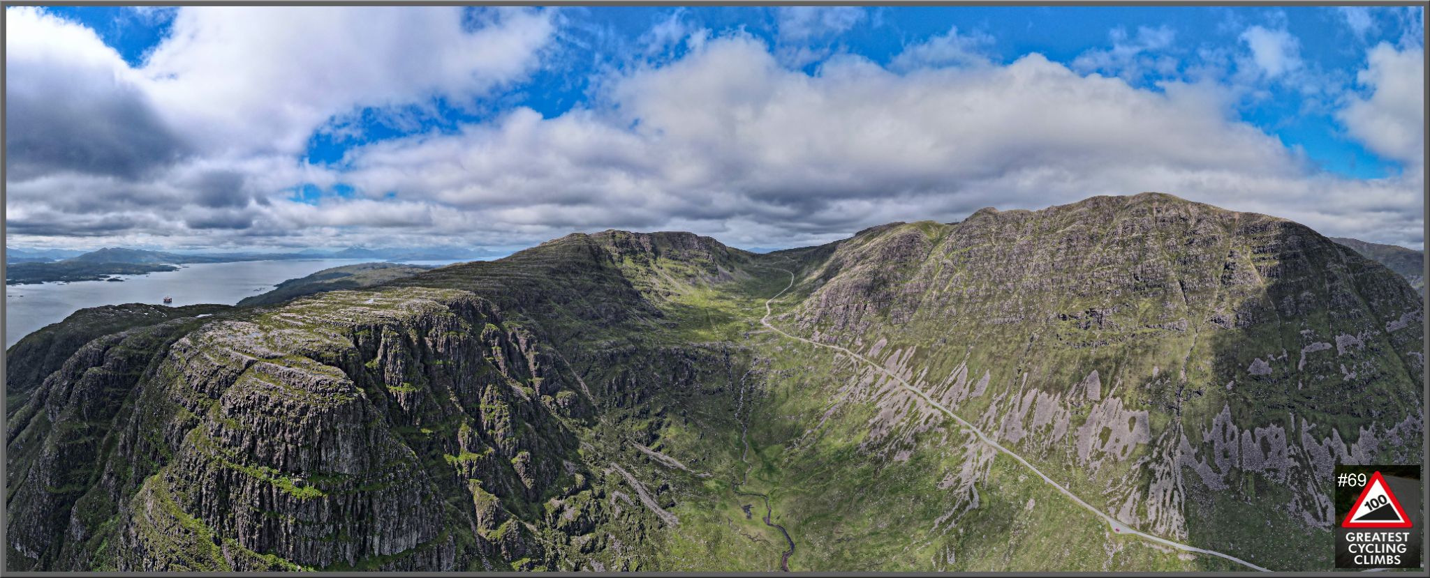panoramic view of Bealach na Bà climb, road cuts through center of mountains