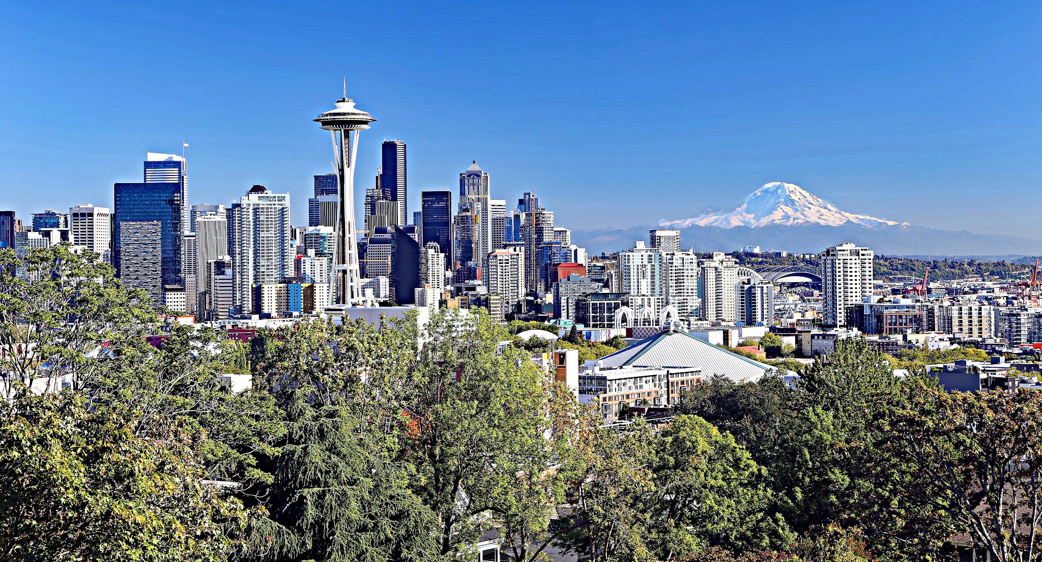 Cycling Mt. Rainier from Nisqually River Entrance - Mt. Rainier as seen in the distance with Seattle city skyline in foreground, taken from Kerry Park in Queen Anne, Seattle