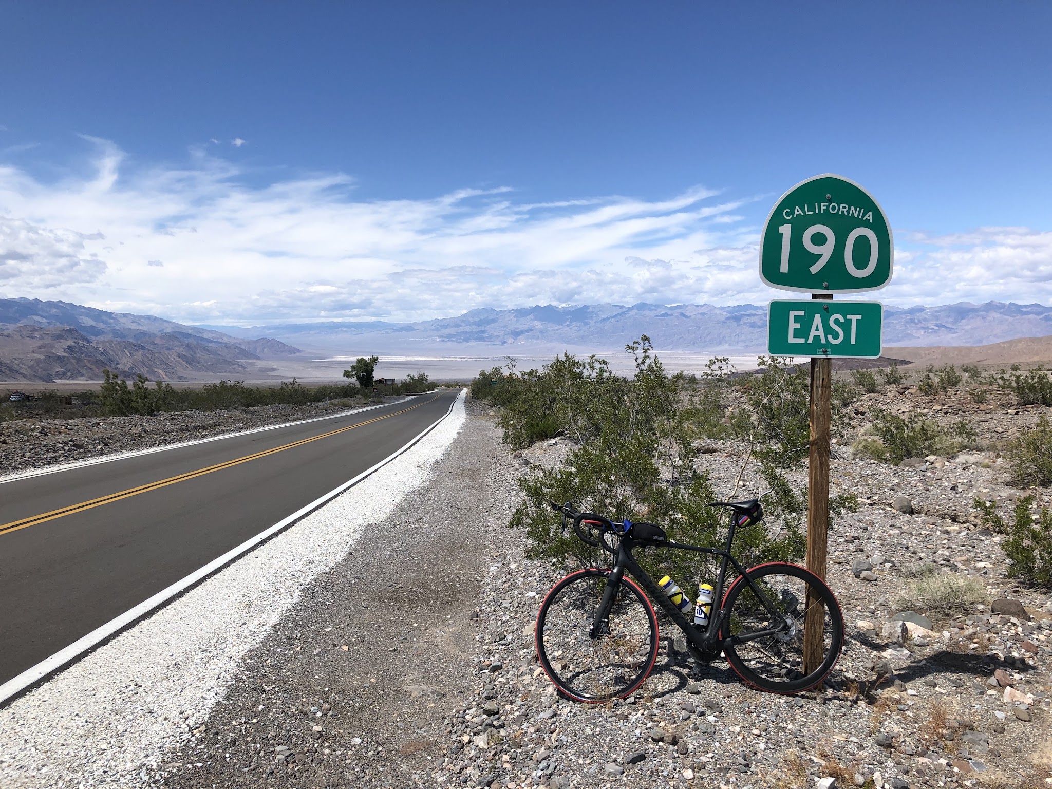 Emigrant Pass, Death Valley National Park Bicycle ride Emigrant Pass, Death Valley - bike leaning against Hwy 190 sign near road