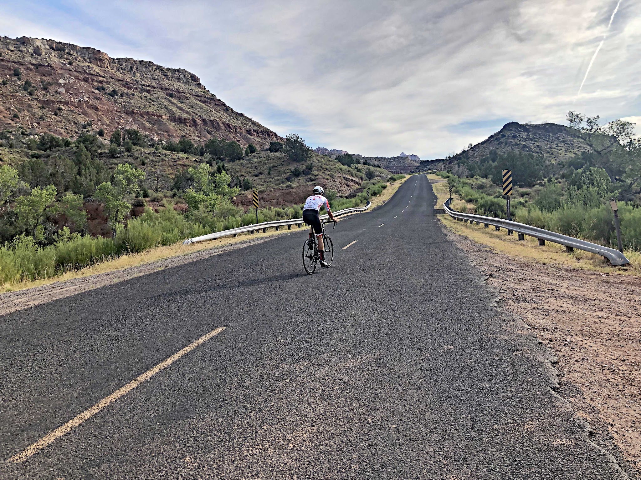 Bicycle ride of Kolob Terrace Road - start - roadway and mountains - cycllist on bike