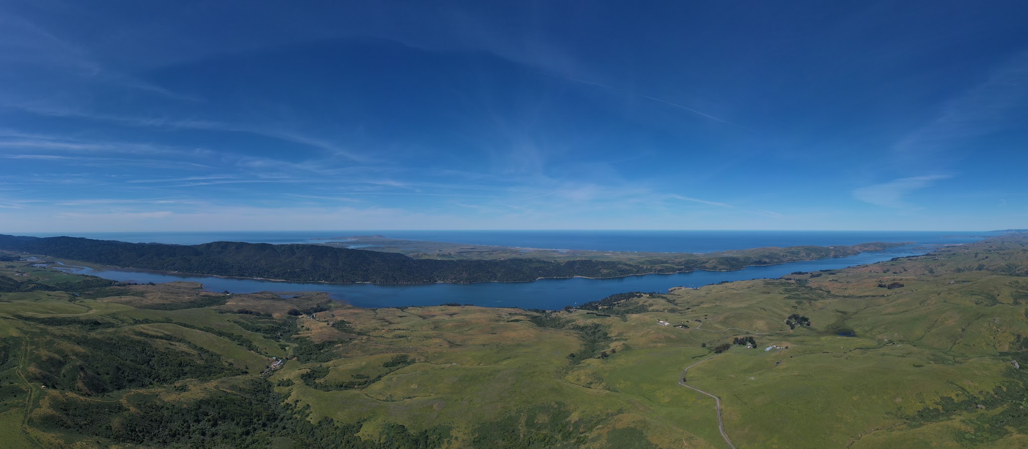 Cycling Marshall Wall West, Marin County, California - view from above of grasslands reaching Tomales Bay