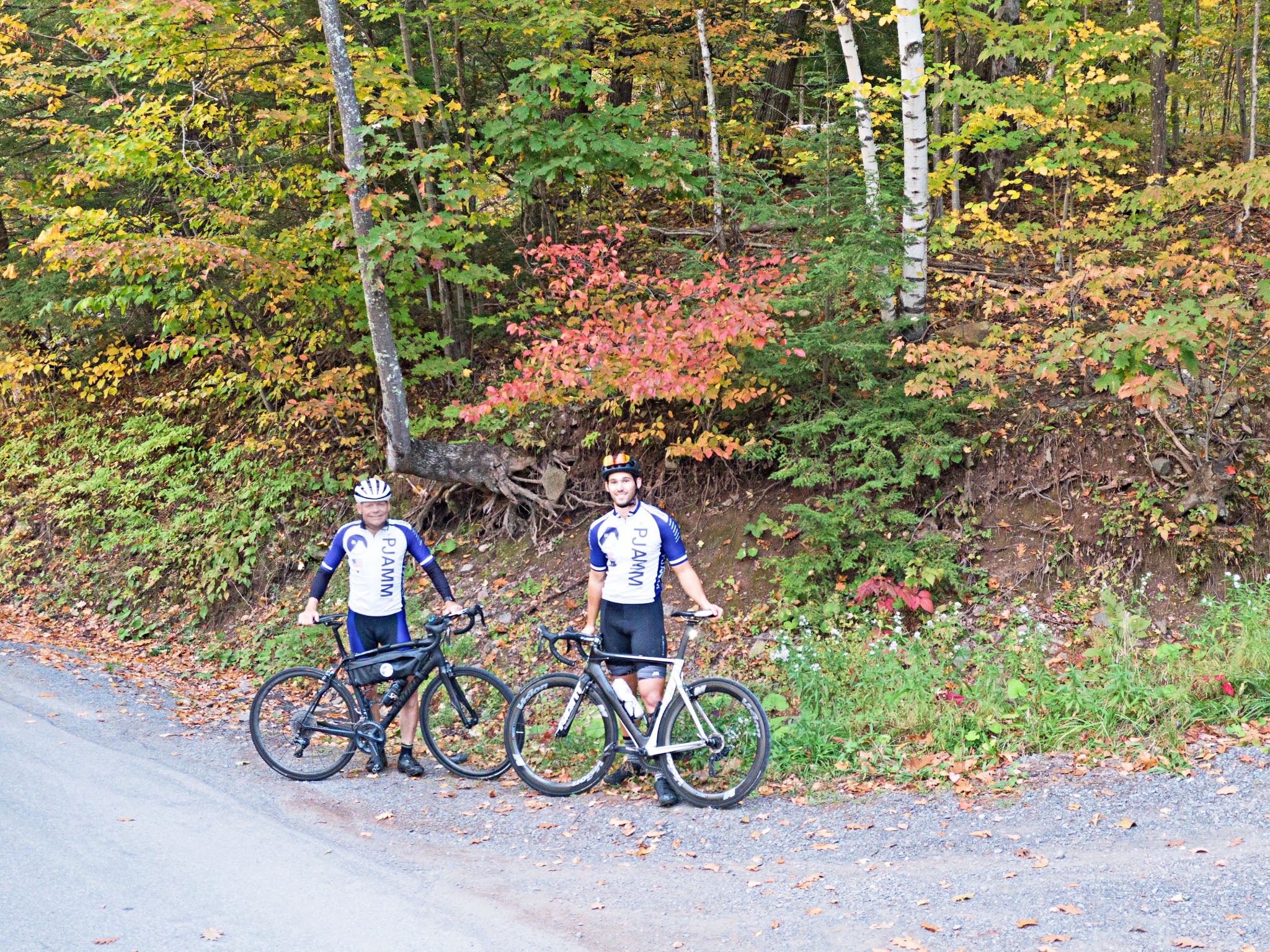 Devil's Kitchen - Platte Clove Road - cyclists in PJAMM Cycling gear standing with bikes along roadside surrounded by fall colors