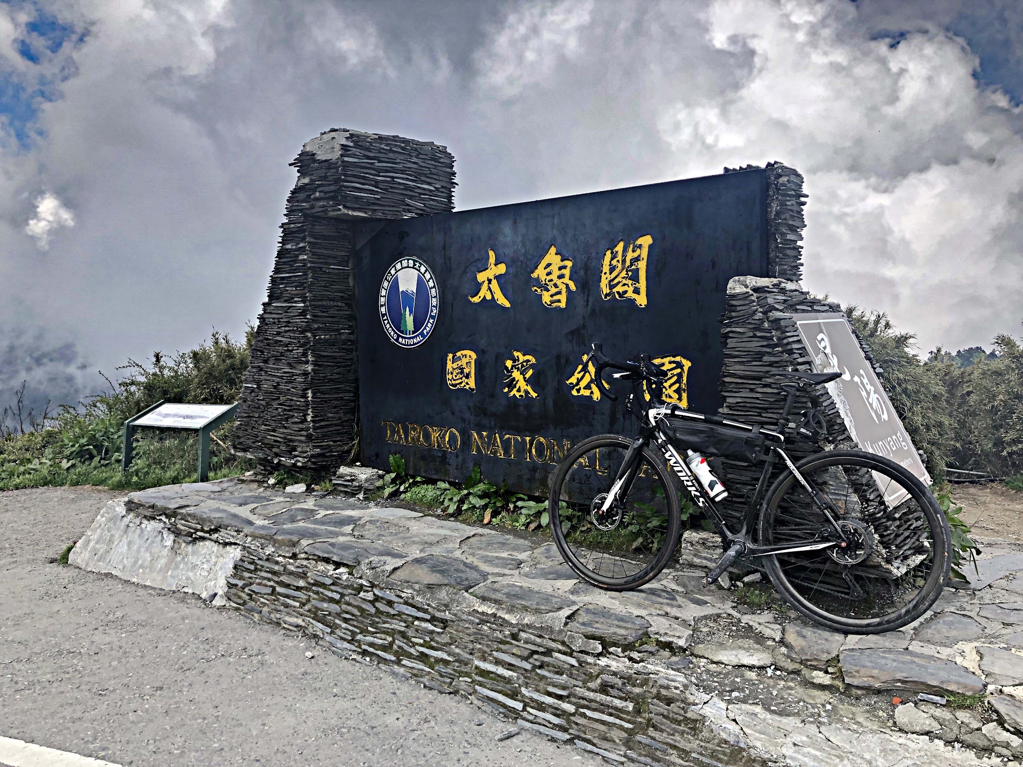 Climbing Wuling Pass West by bike - Cingjing Skywalk from aerial drone, walkway, mountains, farm and reservoir