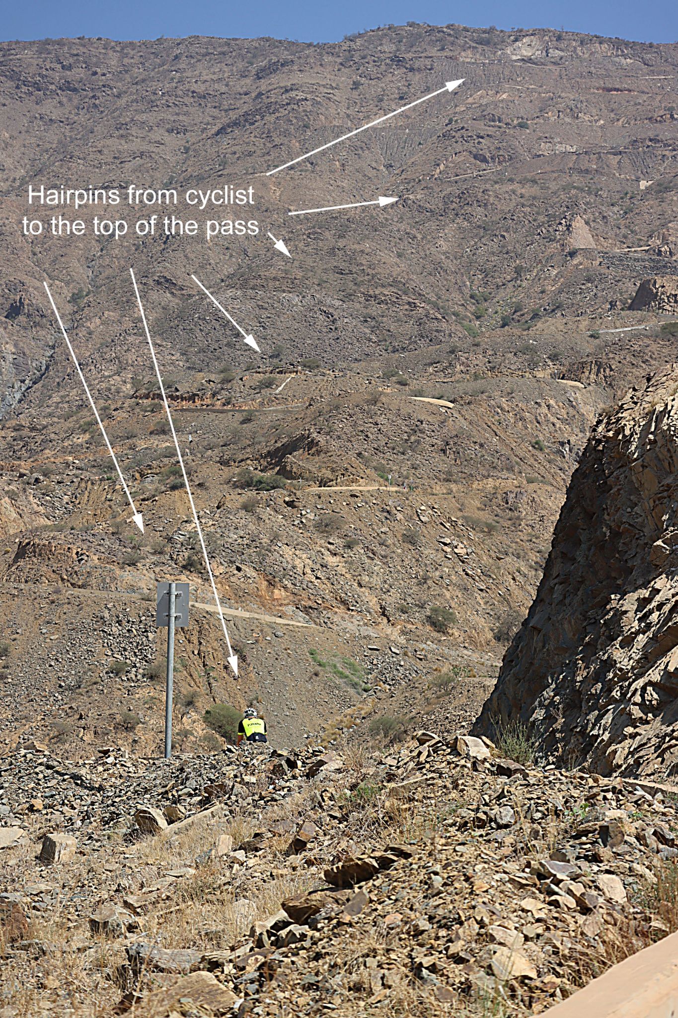 Cycling Beth-rah Pass, Asir Mountains, Saudi Arabia - view from behind PJAMM Cyclist climbing roadway, hairpin turns can be seen up the entire mountainside to the top of the mountain