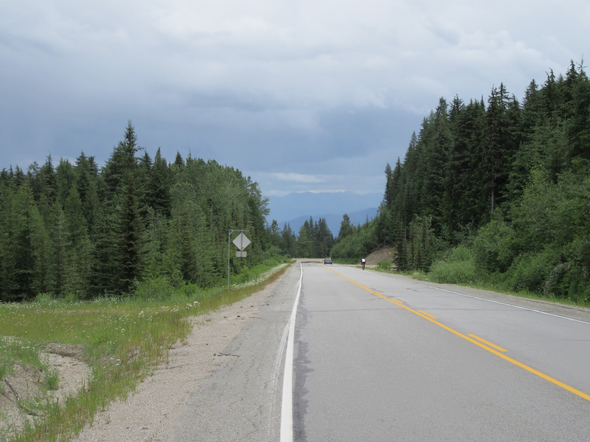 Cycling Strawberry Pass, BC, CAN - cyclists descending roadway