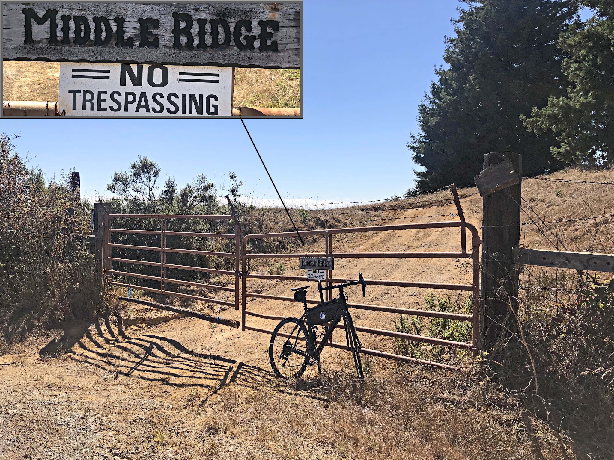 Cycling Mt. Madonna, Santa Cruz Mountains - bike parked in front of medal gate going up a dirt roadway, sign for Middle Ridge, No Trespassing
