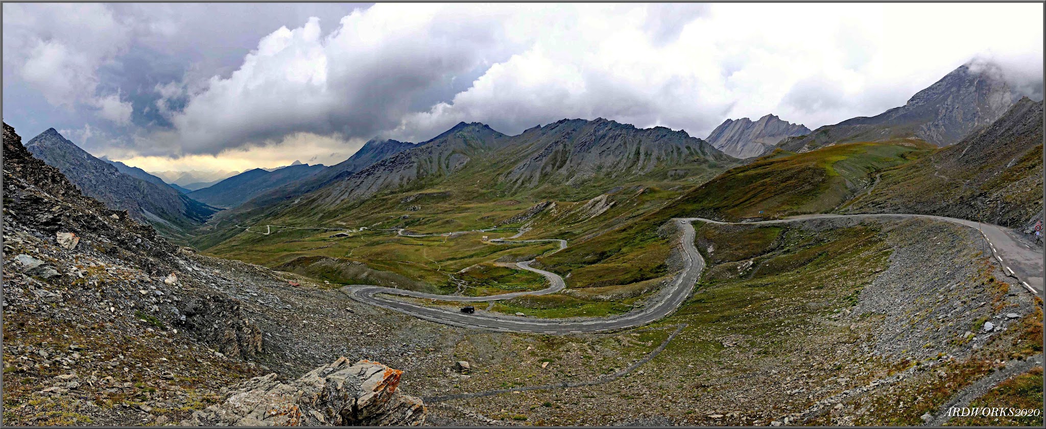 Cycling Colle dell’Agnello, France and Italy - long road winding it's way up mountainside, French and Italian alps