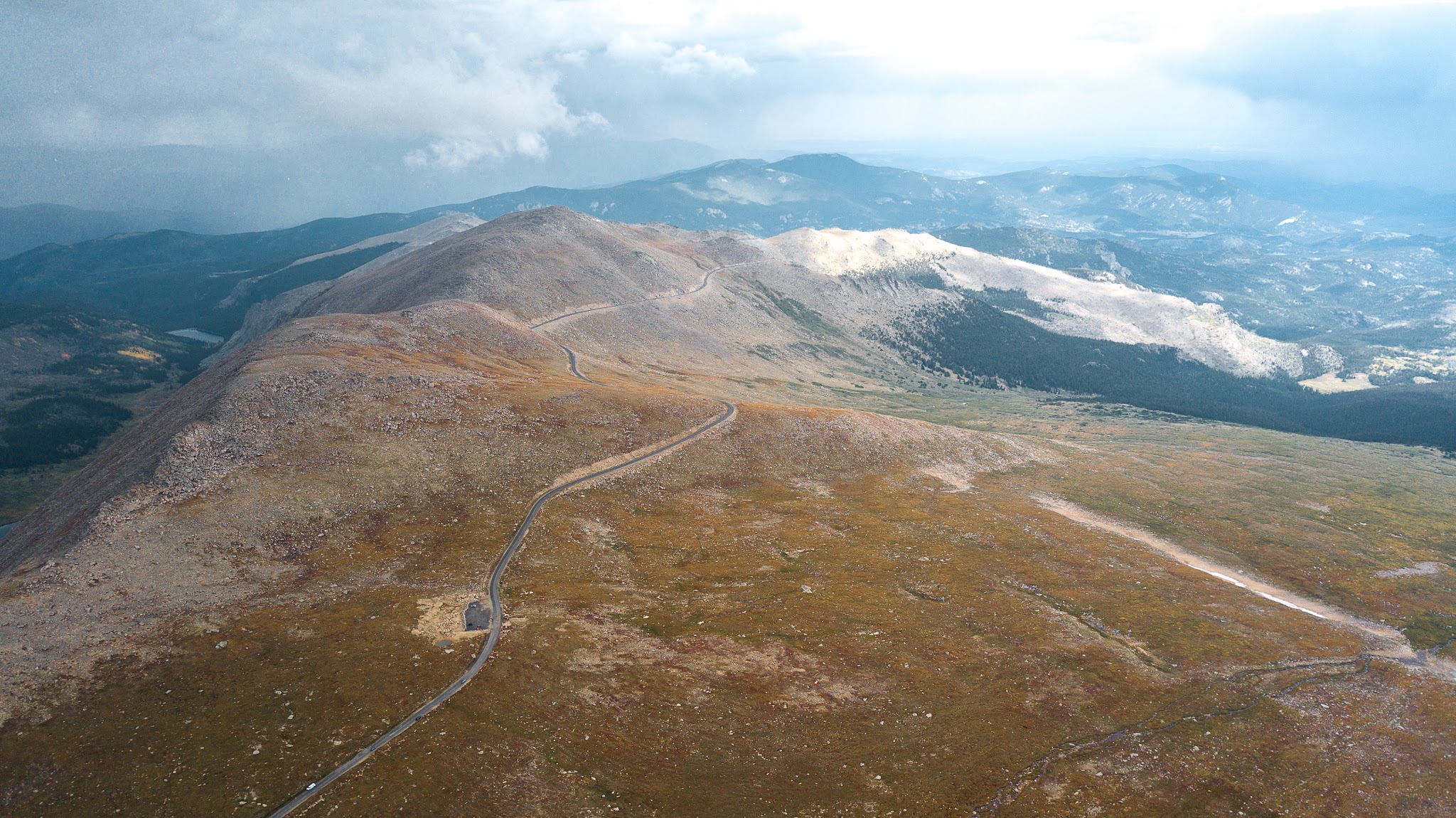 Cycling Highest Colorado bike climb - Hwy 3, road to Mt. Evans, mountains in background