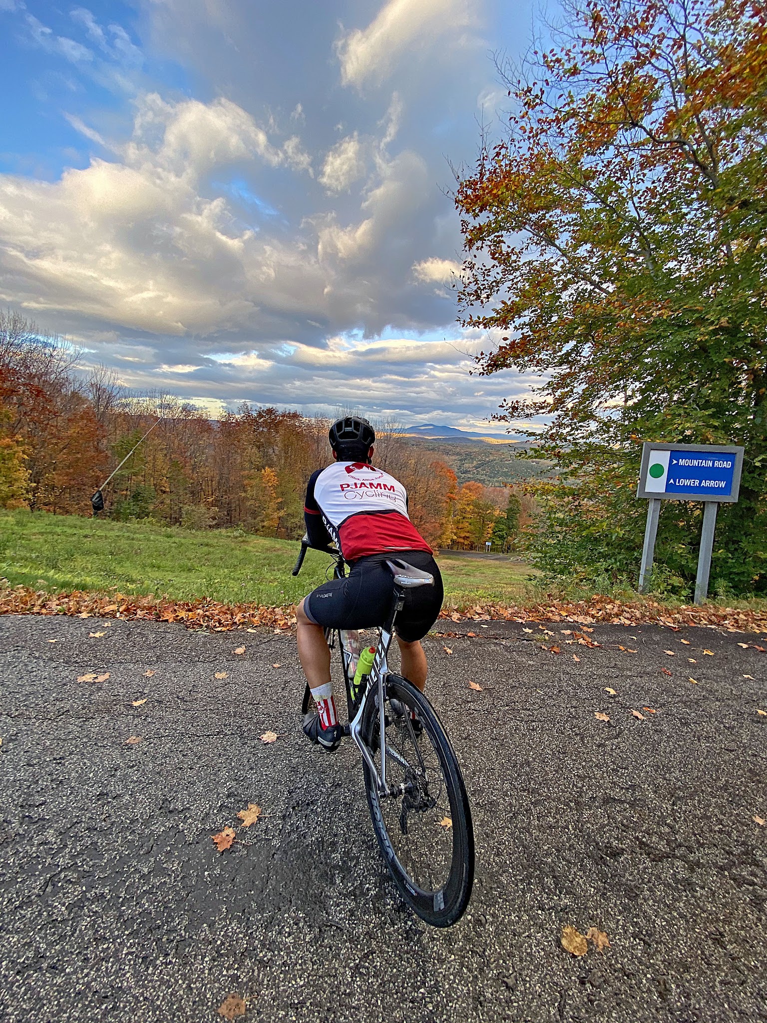 Cycling Okemo, Vermont - Cyclist wearing PJAMM Cycling jersey overlooking fall foliage