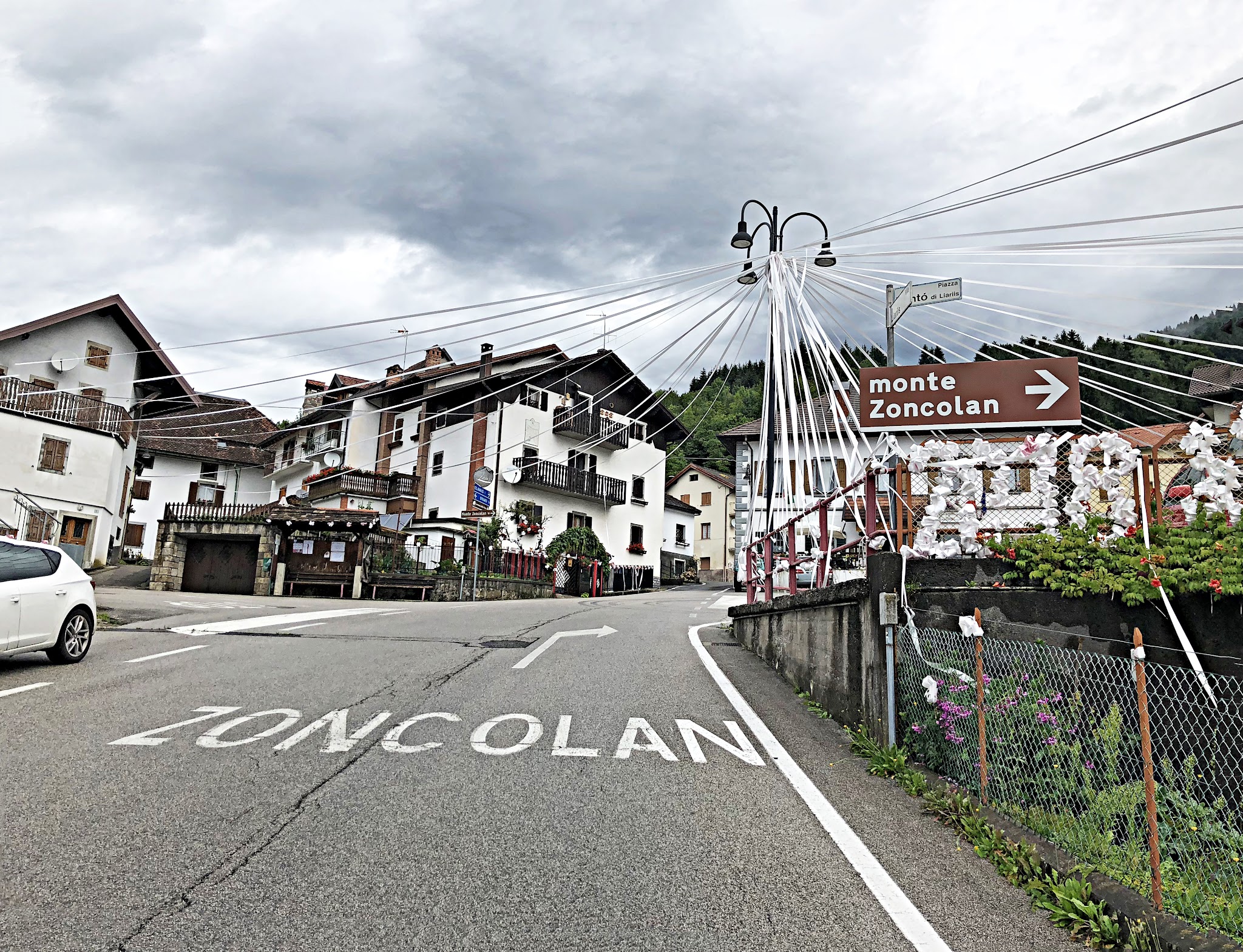 Monte Zoncolan from Ovaro bike climb of Monte Zoncolan from Ovaro - start of climb - town, buildings, road and sign