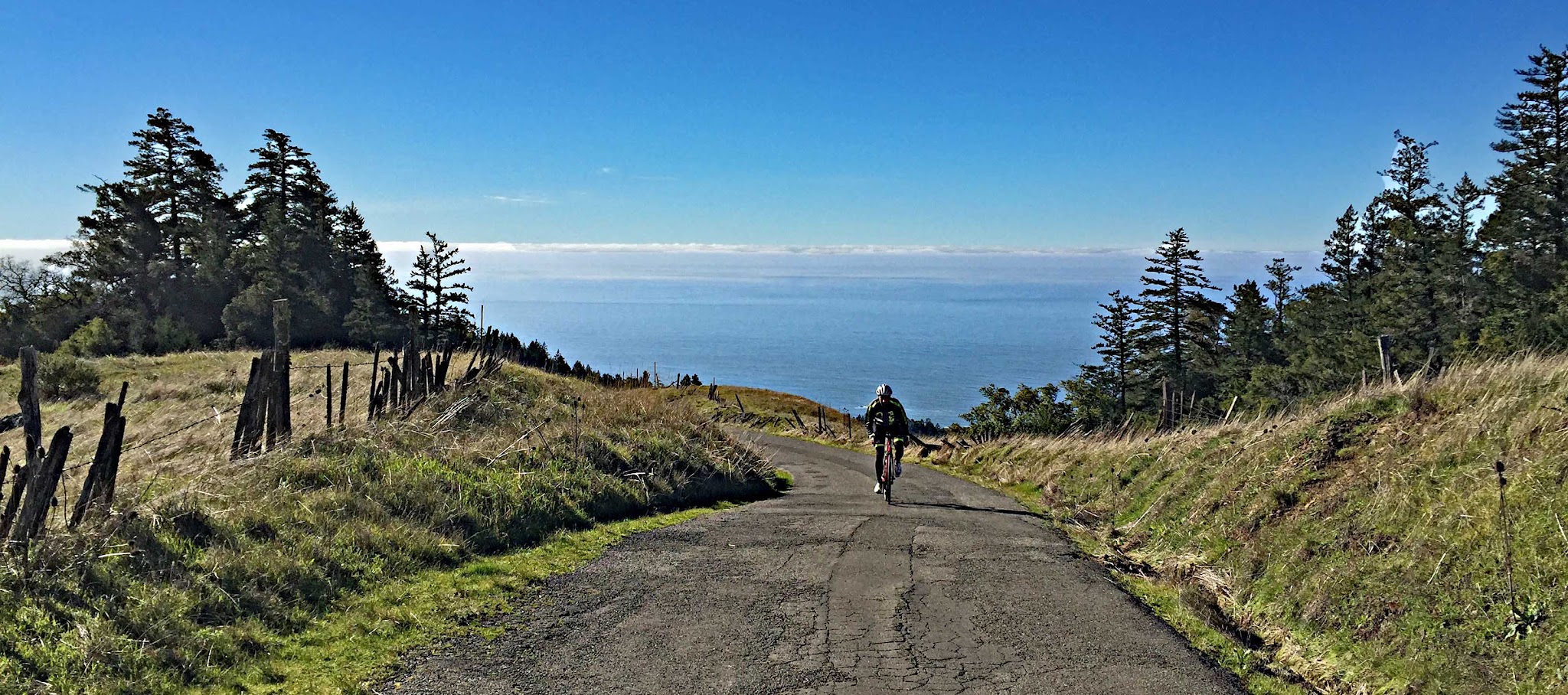 cycling Fort Ross Road - road, fog over Pacific Ocean