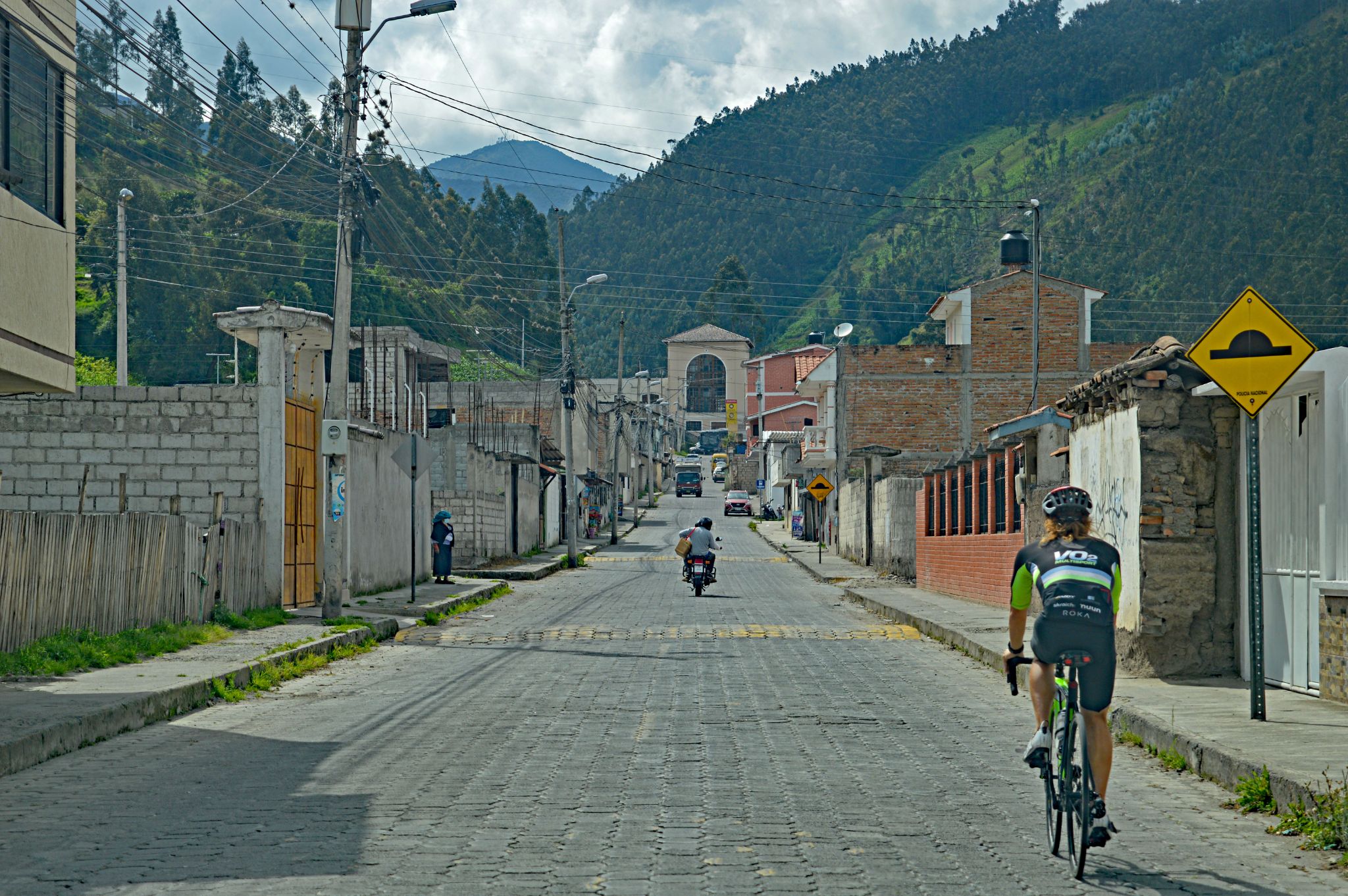 PJAMM Cyclist rides on cobbled roadway at climb's beginning