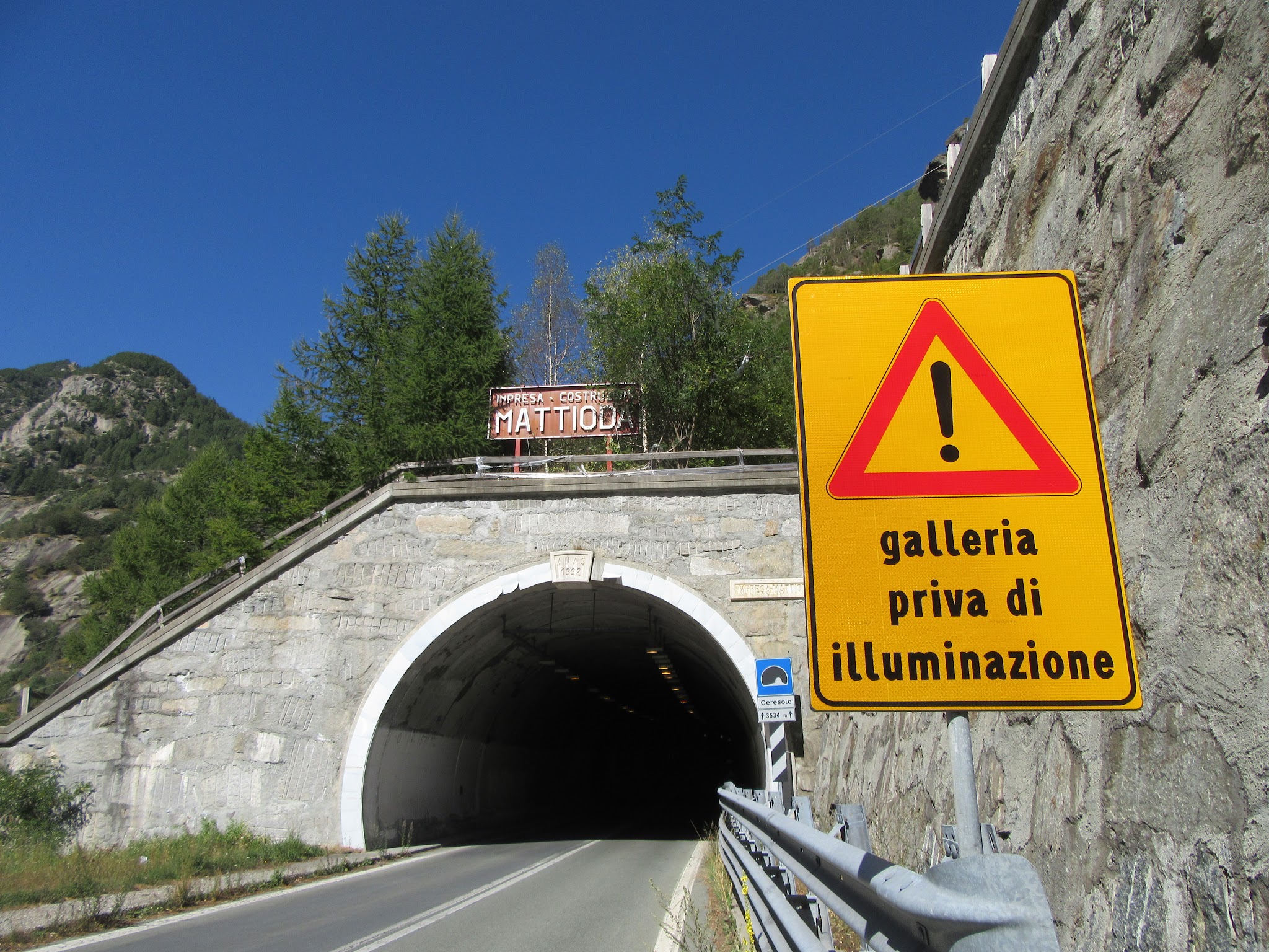 Cycling Colle de Nivolet, Italy - warning sign in front of two-lane tunnel