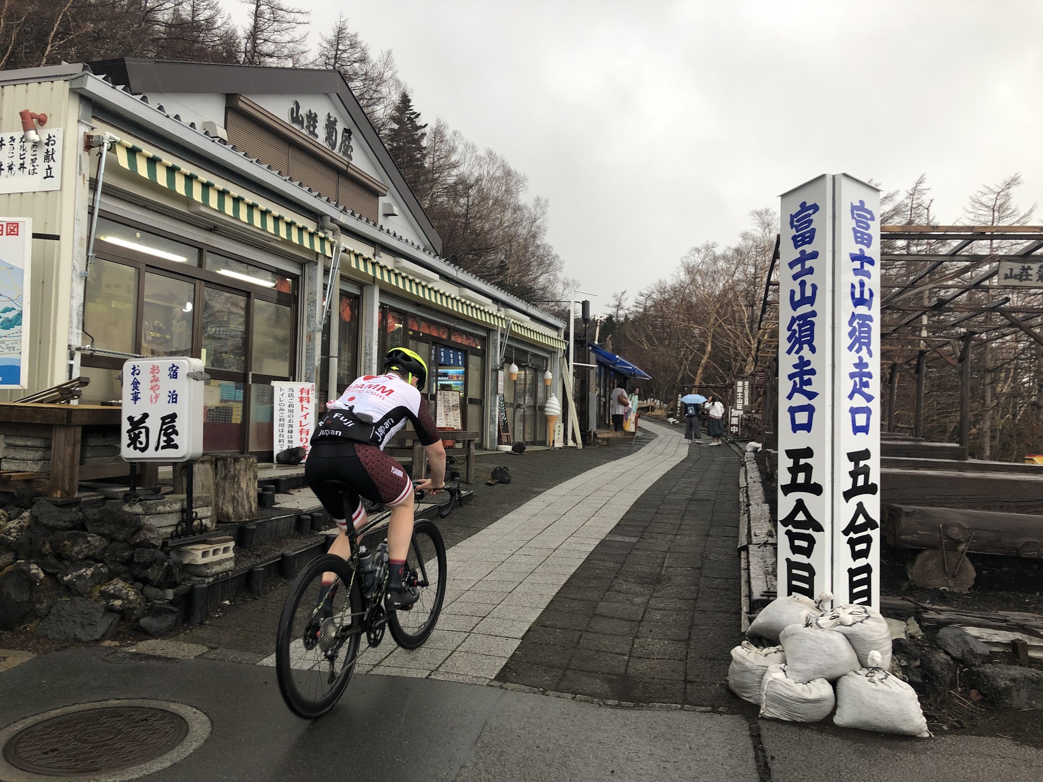 Cycling Mt. Fuji Azami Line - cyclist on walkway at finish of climb at 5th station