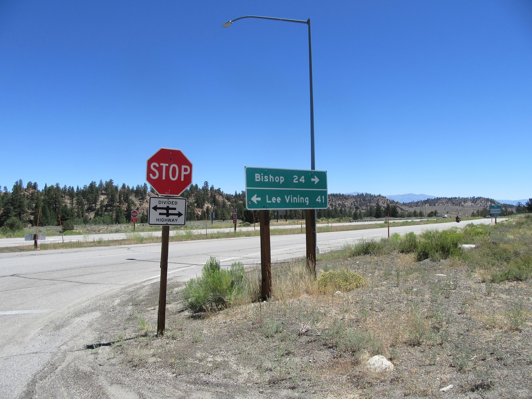 Hwy 395 sign at Rock Creek Road bicycling to top