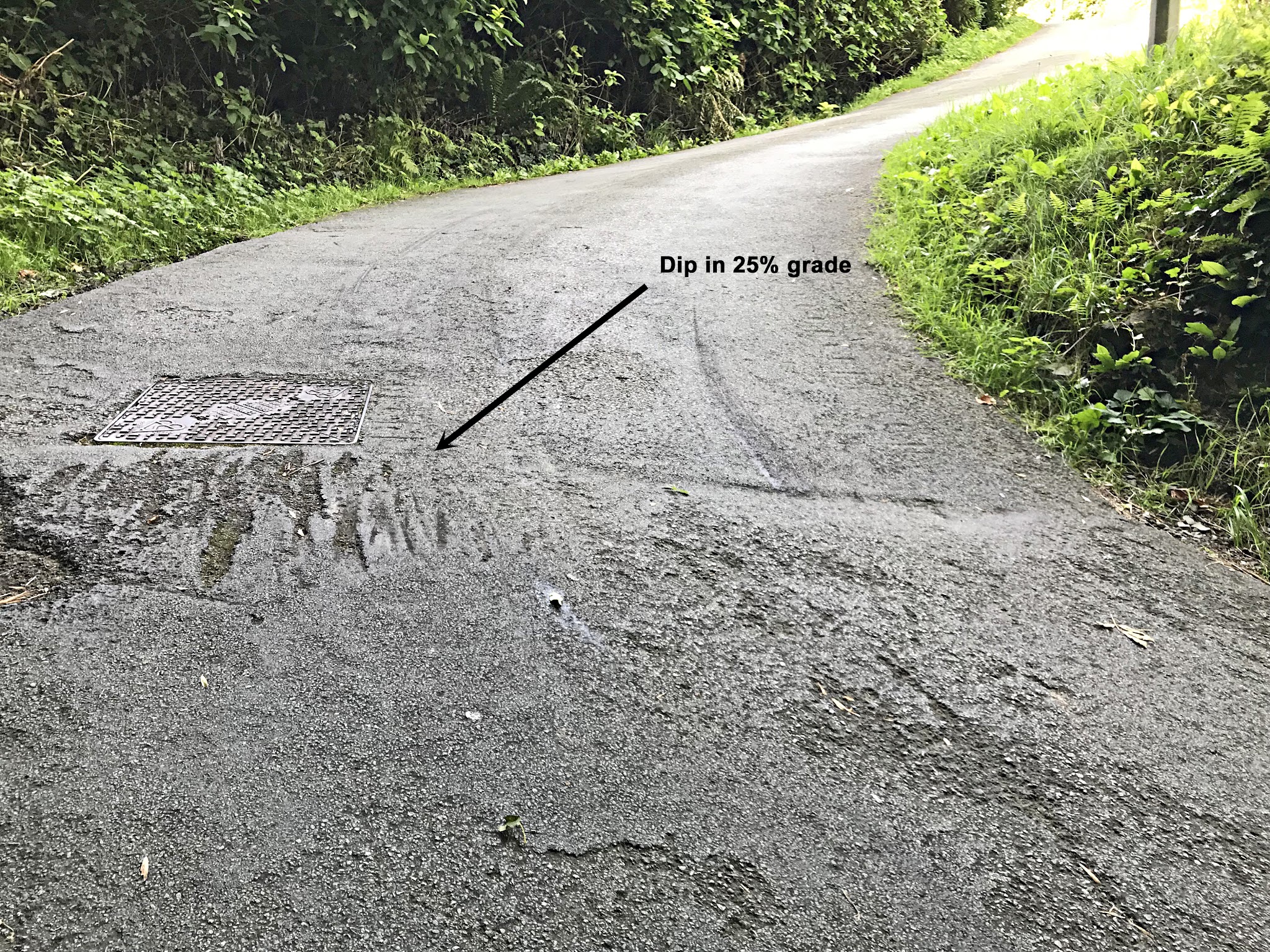 Cycling Ffordd Pen Llech, Wales - close up view of extreme gradient of roadway, roadway torn up in places from cars bottoming out on it