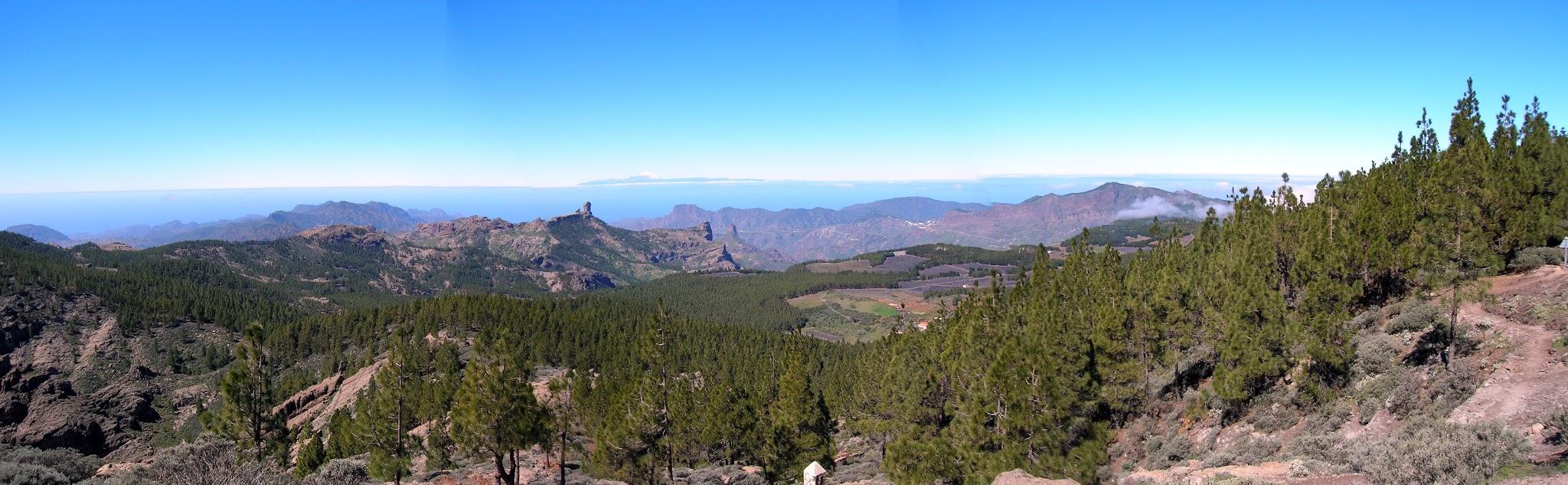 panoramic view of mountain and forest setting with beautiful mountain and plateau silhouettes in distance