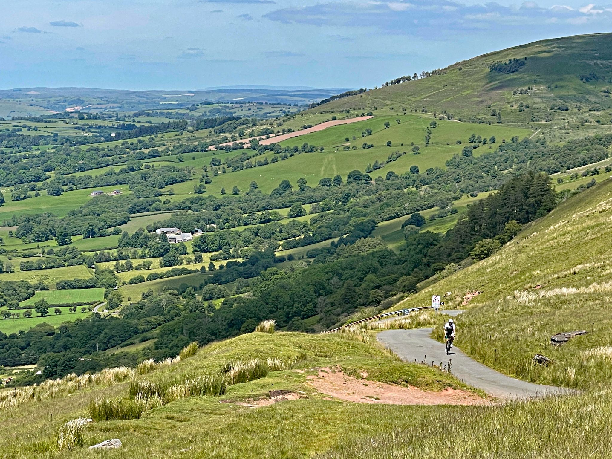 PJAMM Cyclist rides along one-lane roadway to top of Devil's Elbow climb