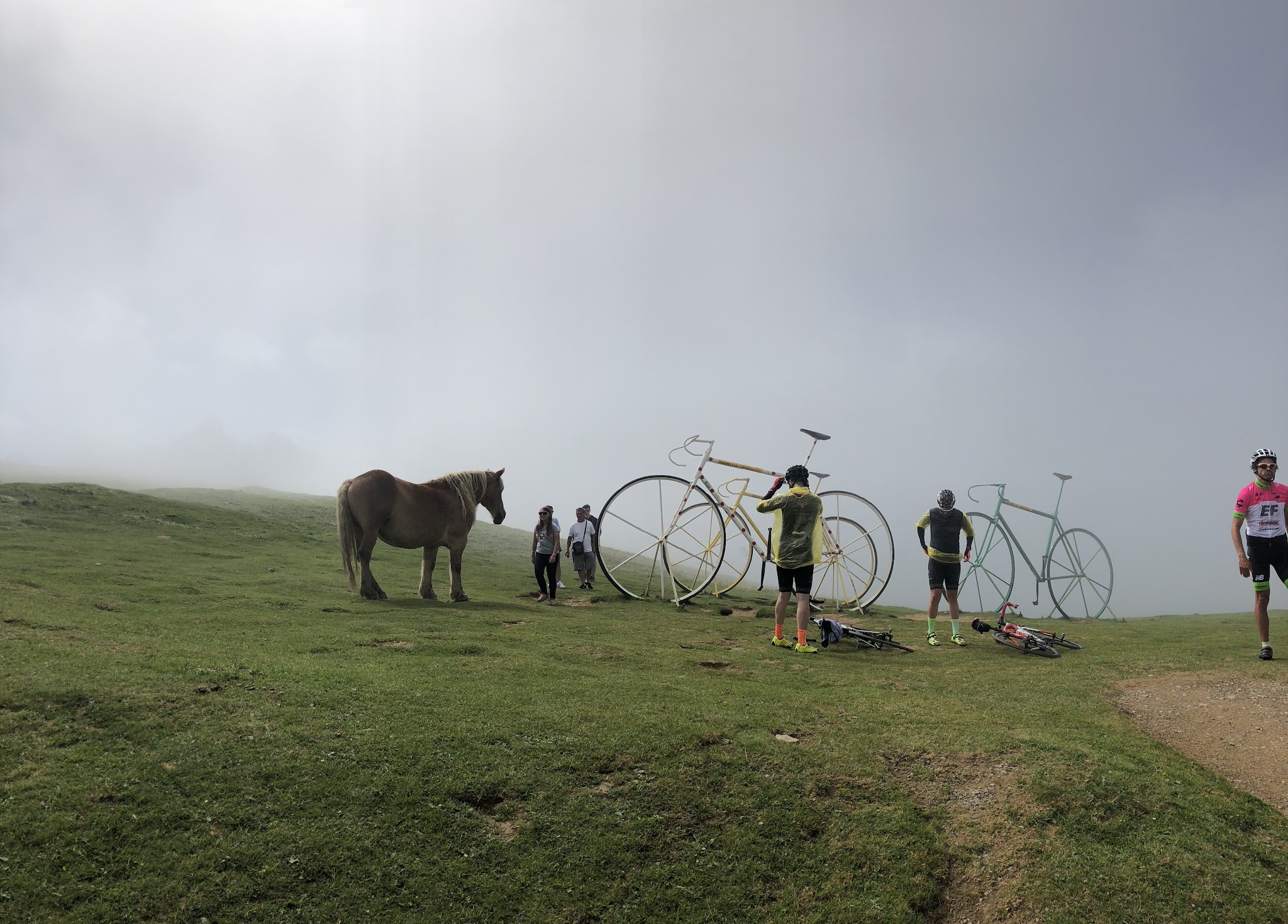 Bike ride Col d'Aubisque from Ferrières - giant bikes, horses and cyclists at top of col