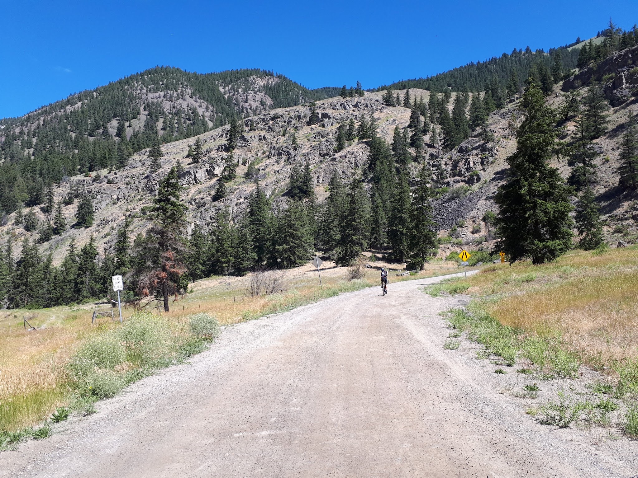 Cycling Hedley to Apex - cyclist on road, mountains in front