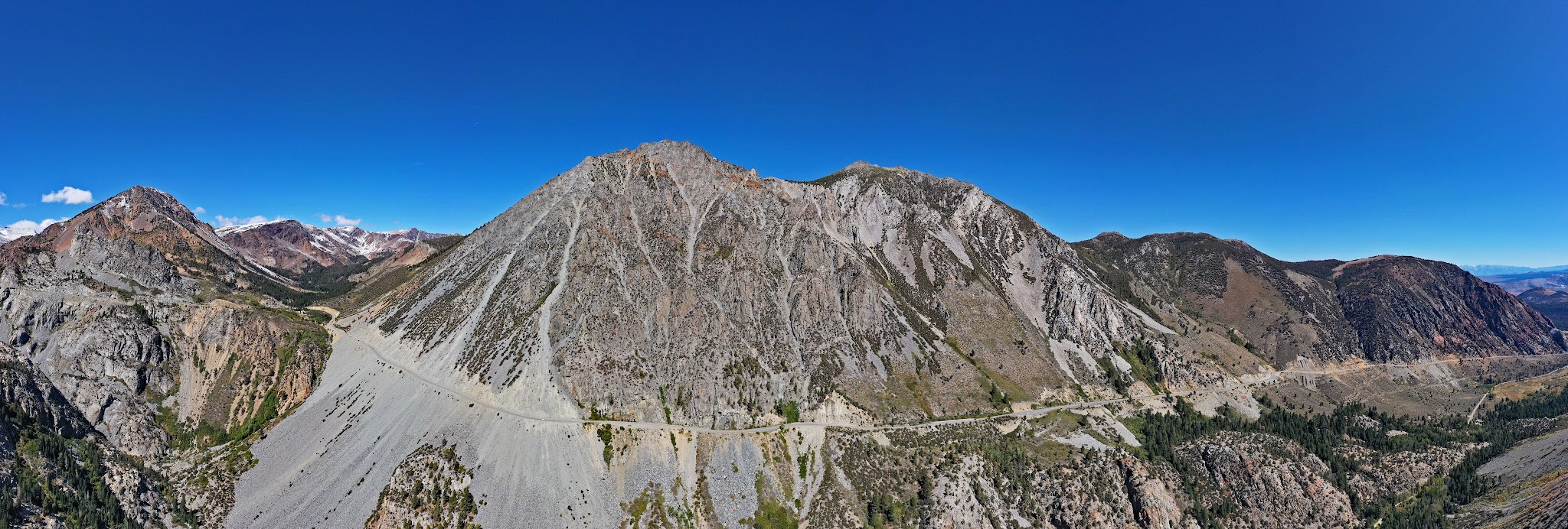 US Most Epic Bike Climbs - Tioga Pass, roadway, sheer cliff, mountains.