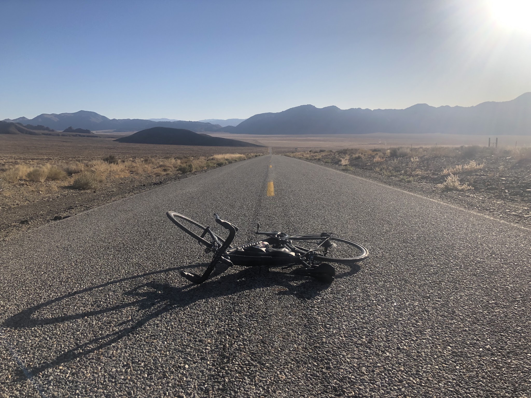cycling White Mountain Road - Bristlecone Forest - cyclist riding bike through narrow canyon on hwy 168