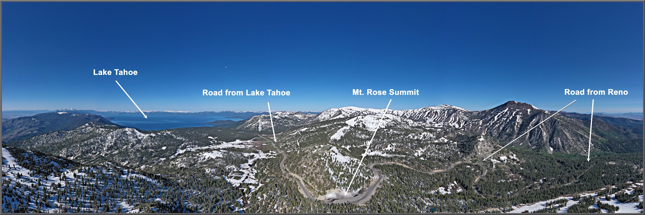 Cycling Mt. Rose East, Nevada - aerial panoramic photo shows Lake Tahoe, the road from Lake Tahoe, Mt. Rose Summit, and the road from Reno, snow capped mountains, blue sky