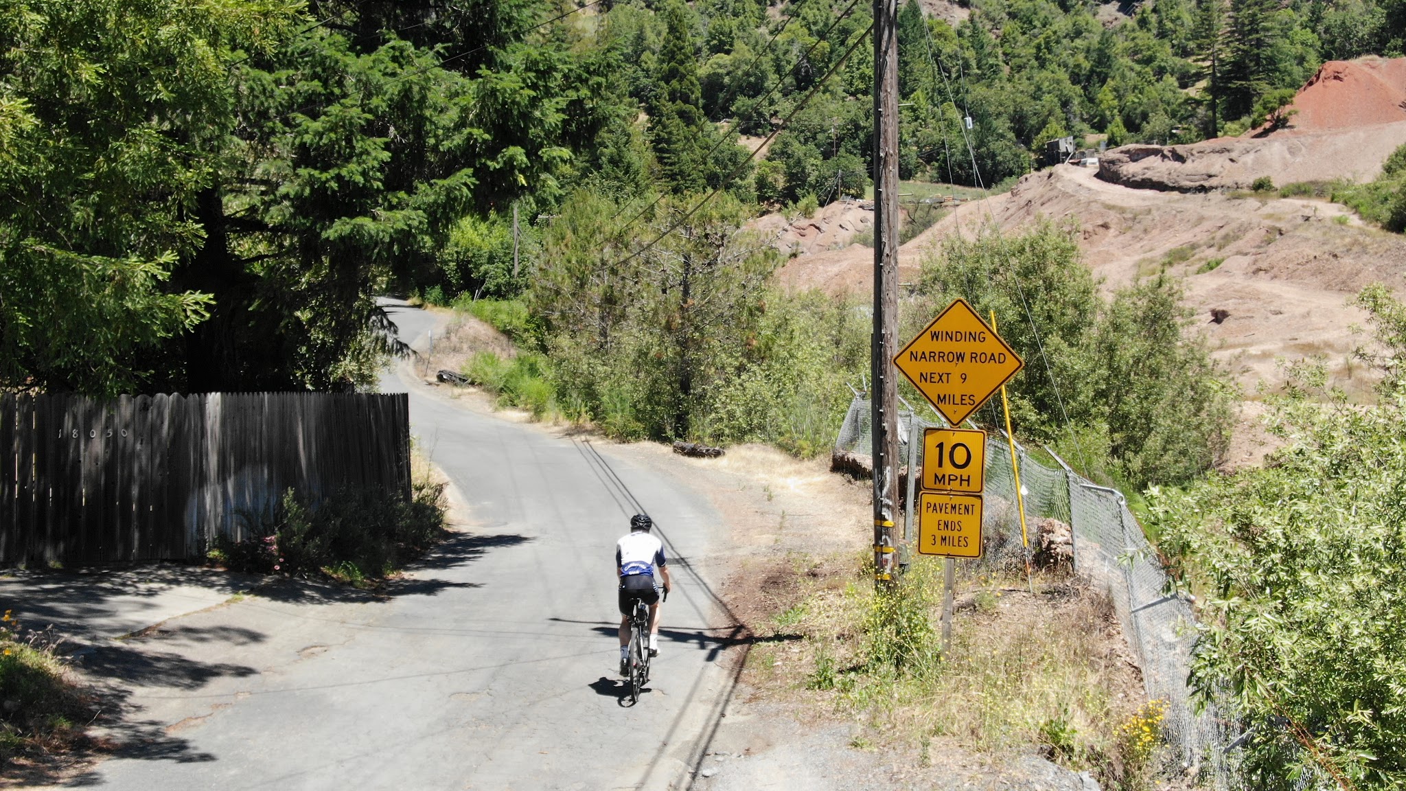 Cycling Sweetwater Springs Road - cyclist riding past road sign at start