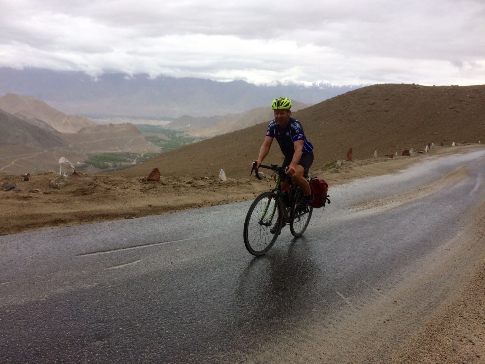 Climbing by bike Khardung La Pass - cyclist on road
