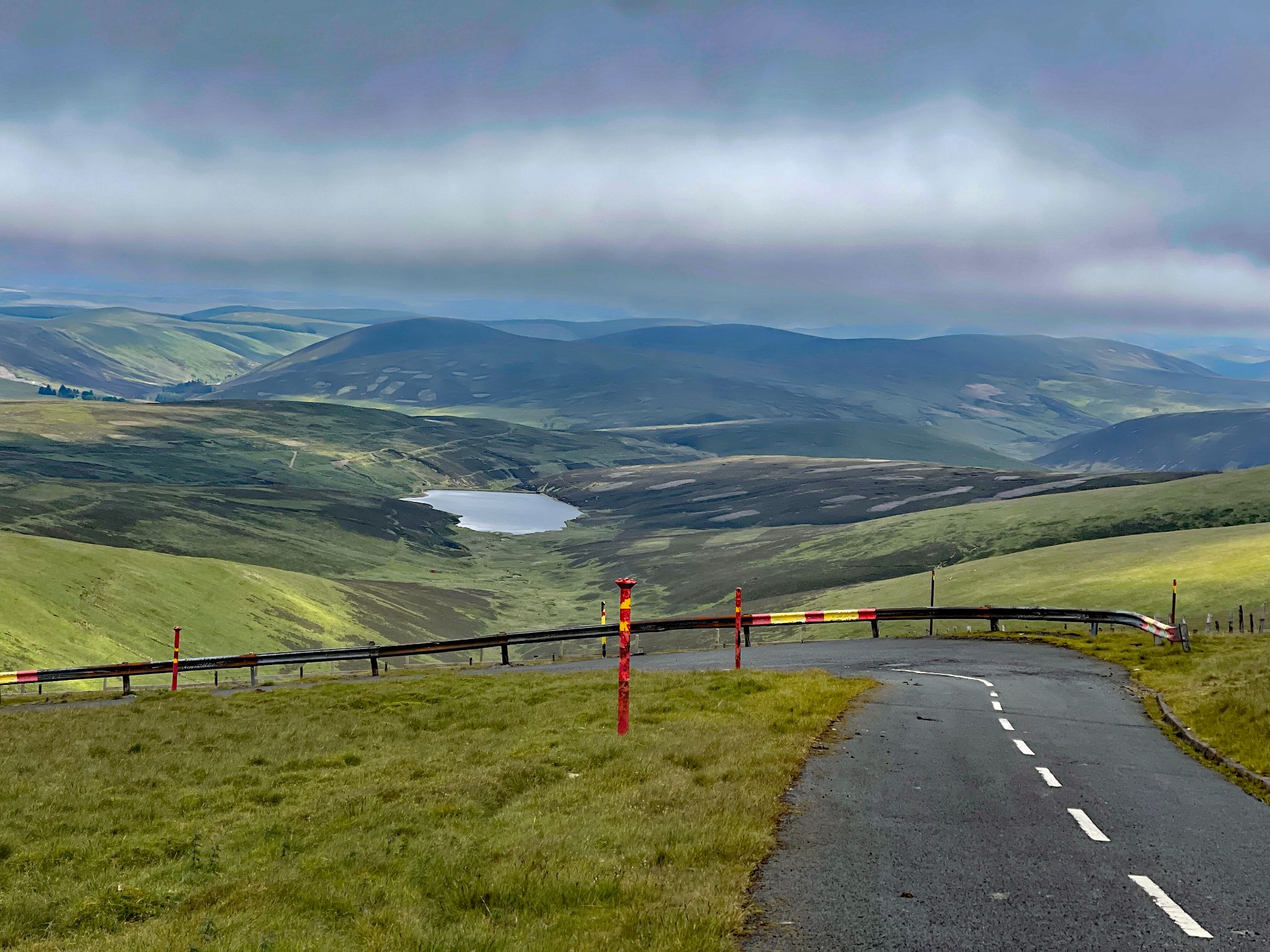 view from Lowther Hill Radar Station looking down at the road up the hill; pond in distance