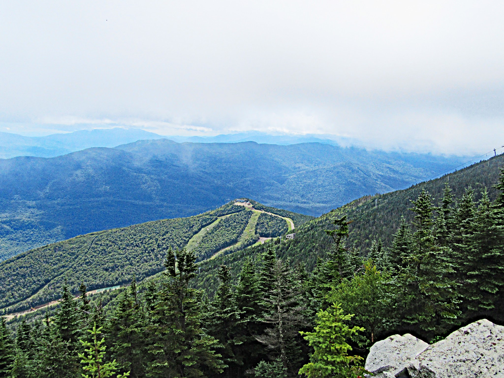Cycling Whiteface Mountain - view from above of Whiteface Mountain Ski Resort slopes in summertime, mountainside is lush green