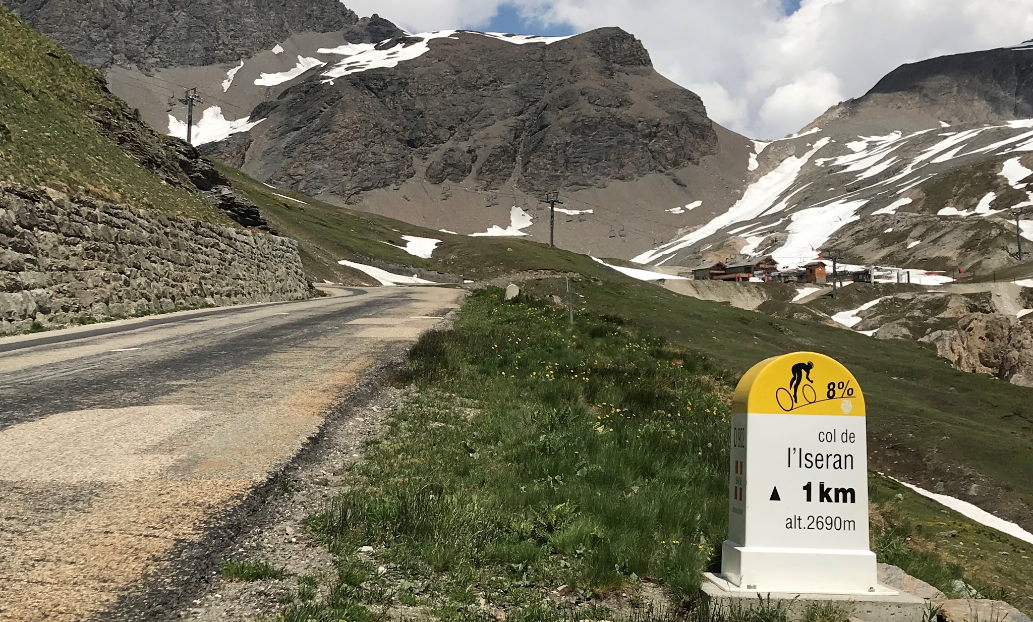 Cycling Col de l’Iseran - cyclist on bike, road, mountains, sky