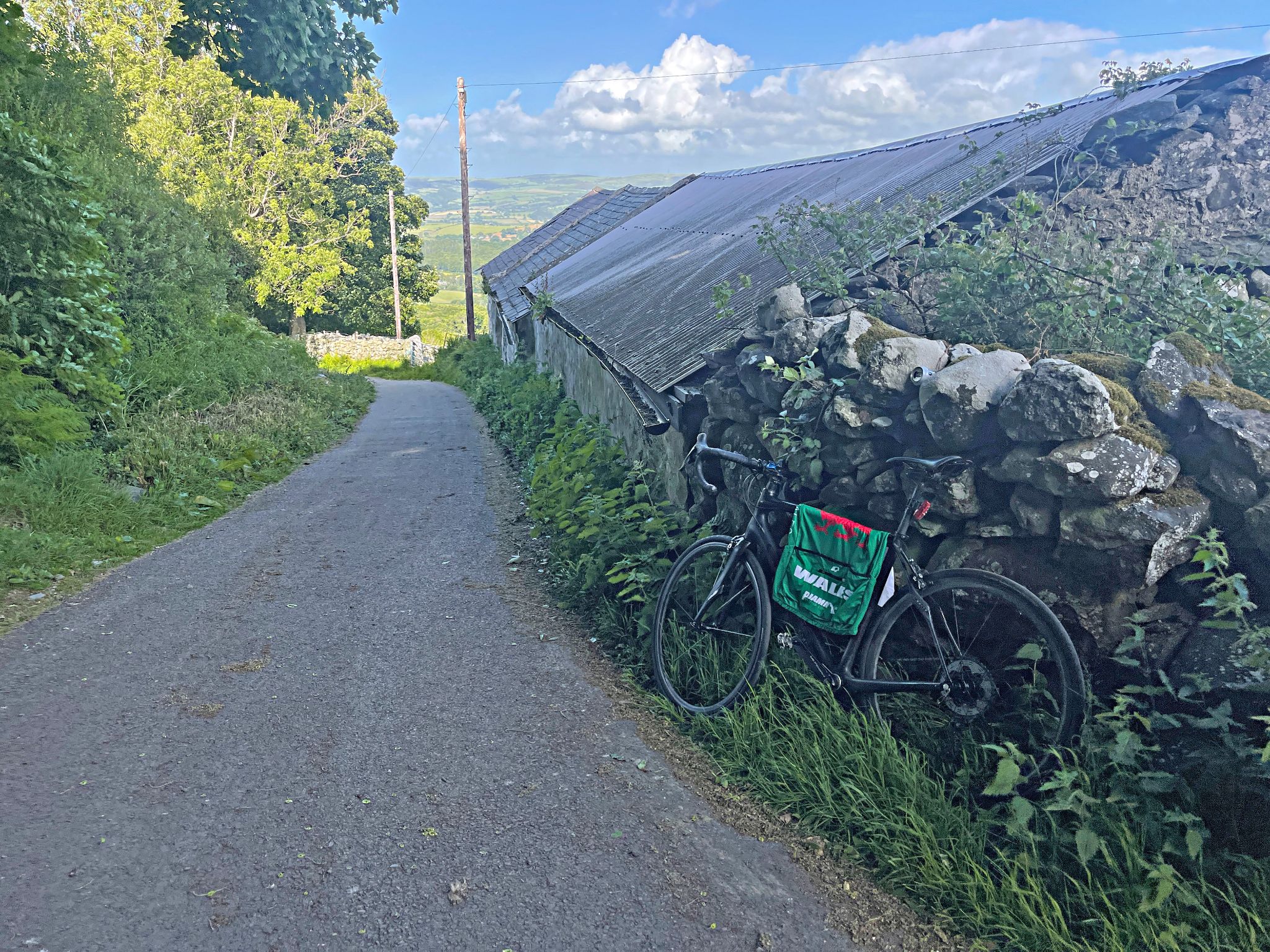 bike parked against stone wall at the climb finish