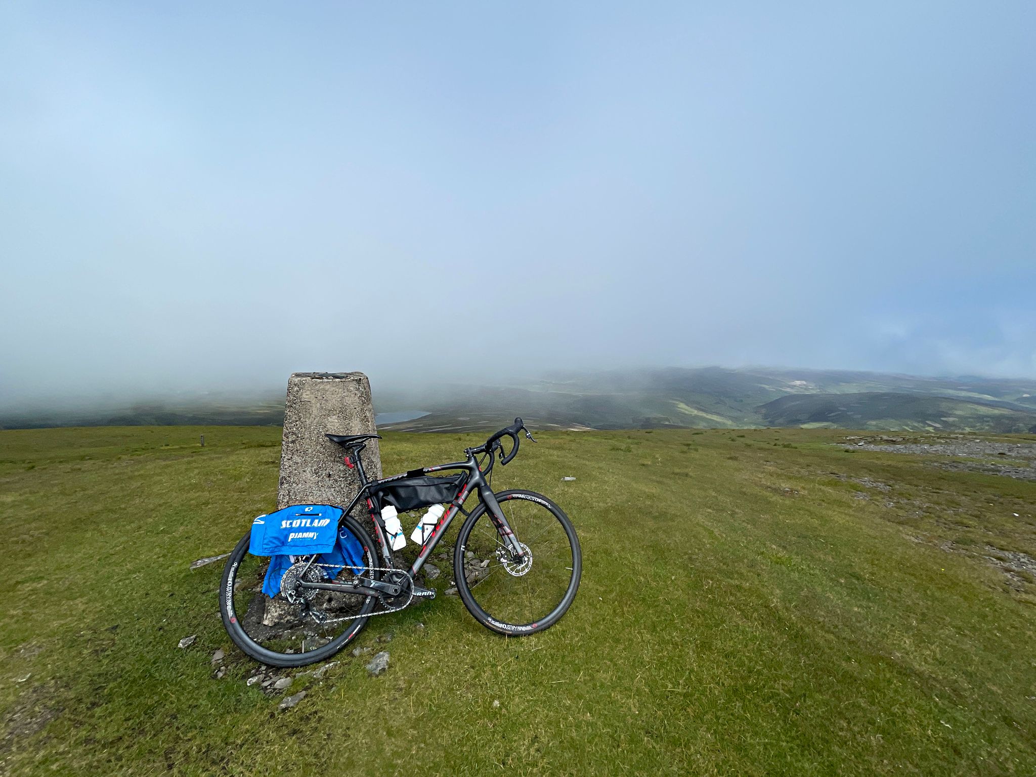 bike parked against cement block at the top of Green Lowther peak at climb finish