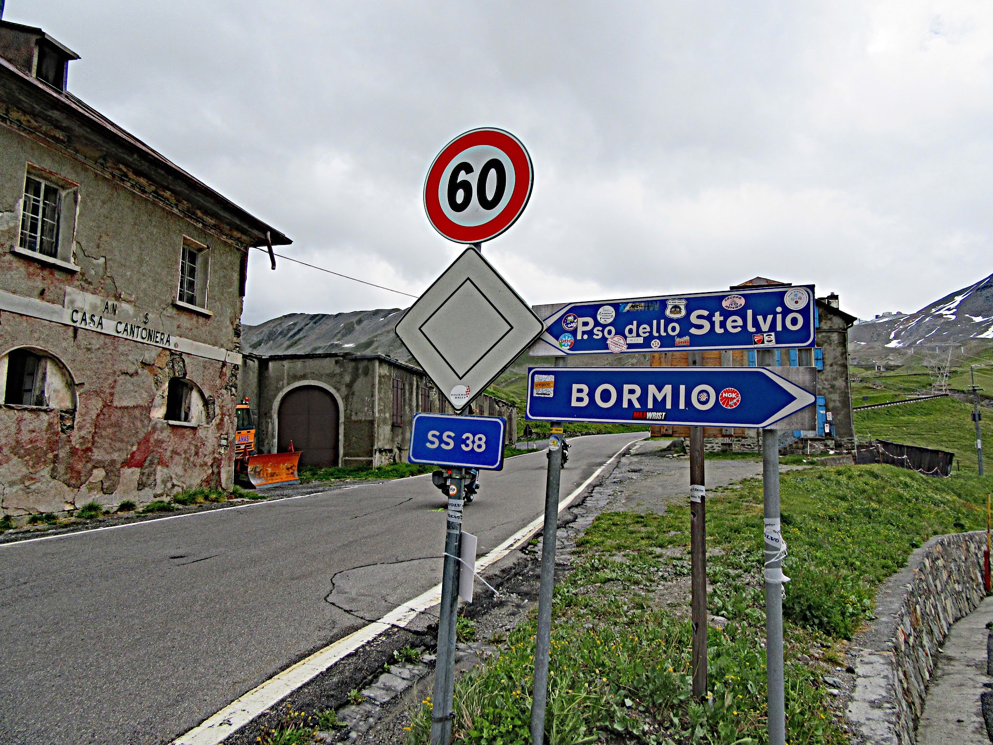 climbing Umbrail Pass by bike - sign to Passo Stelvio and Bormio, road, roadhouse