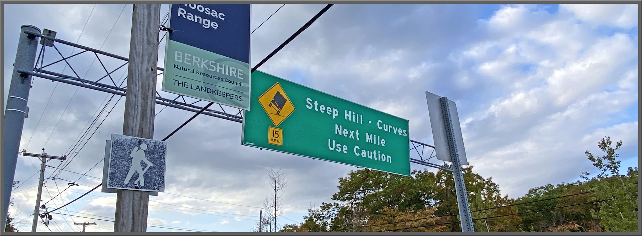 Cycling Mohawk Trail West, Massachusetts - road signs read "Steep Hill - Curves, Next Mile Use Caution"
