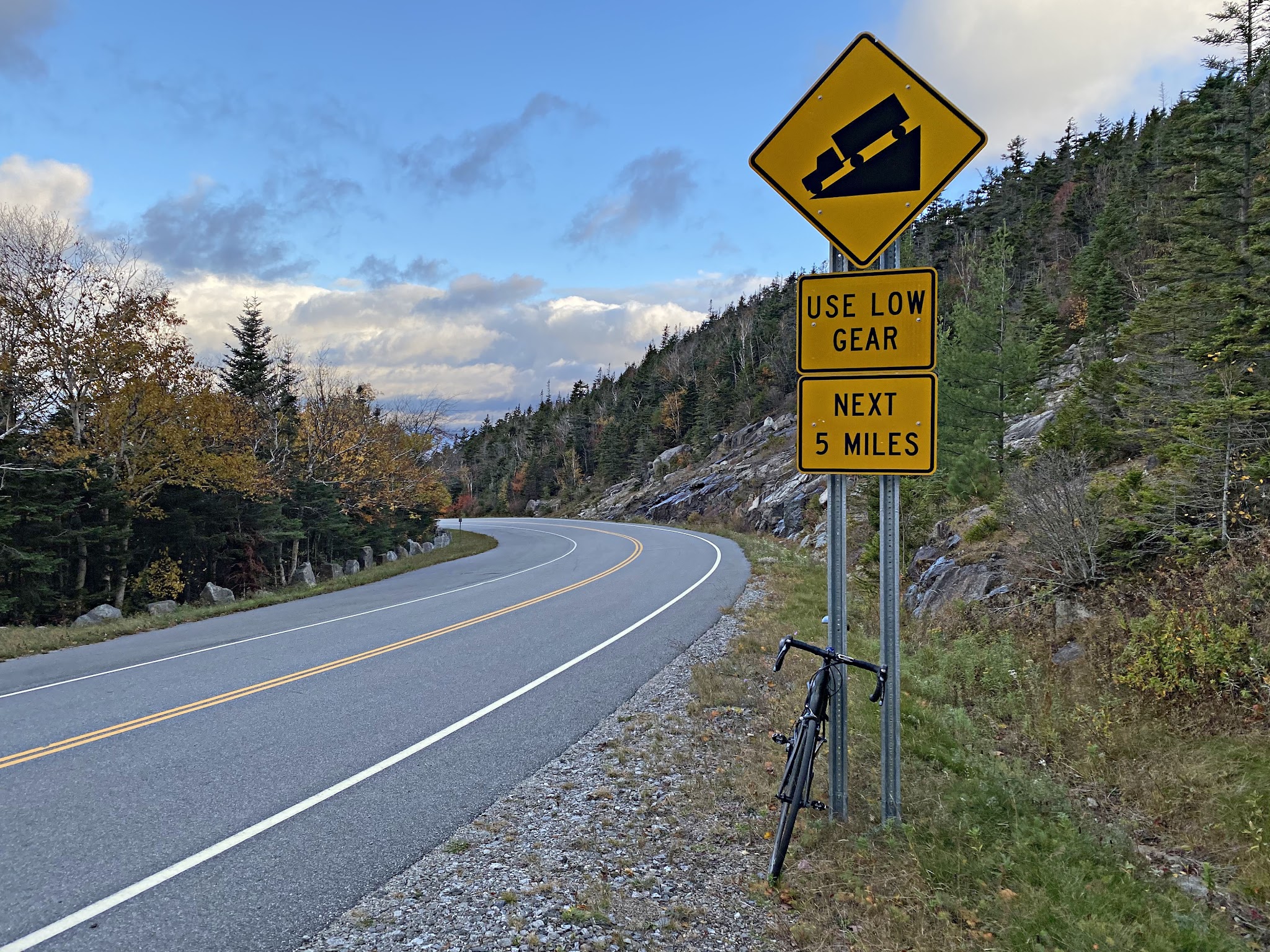Cycling Whiteface Mountain, New York - bike leaning against road sign for steep grade