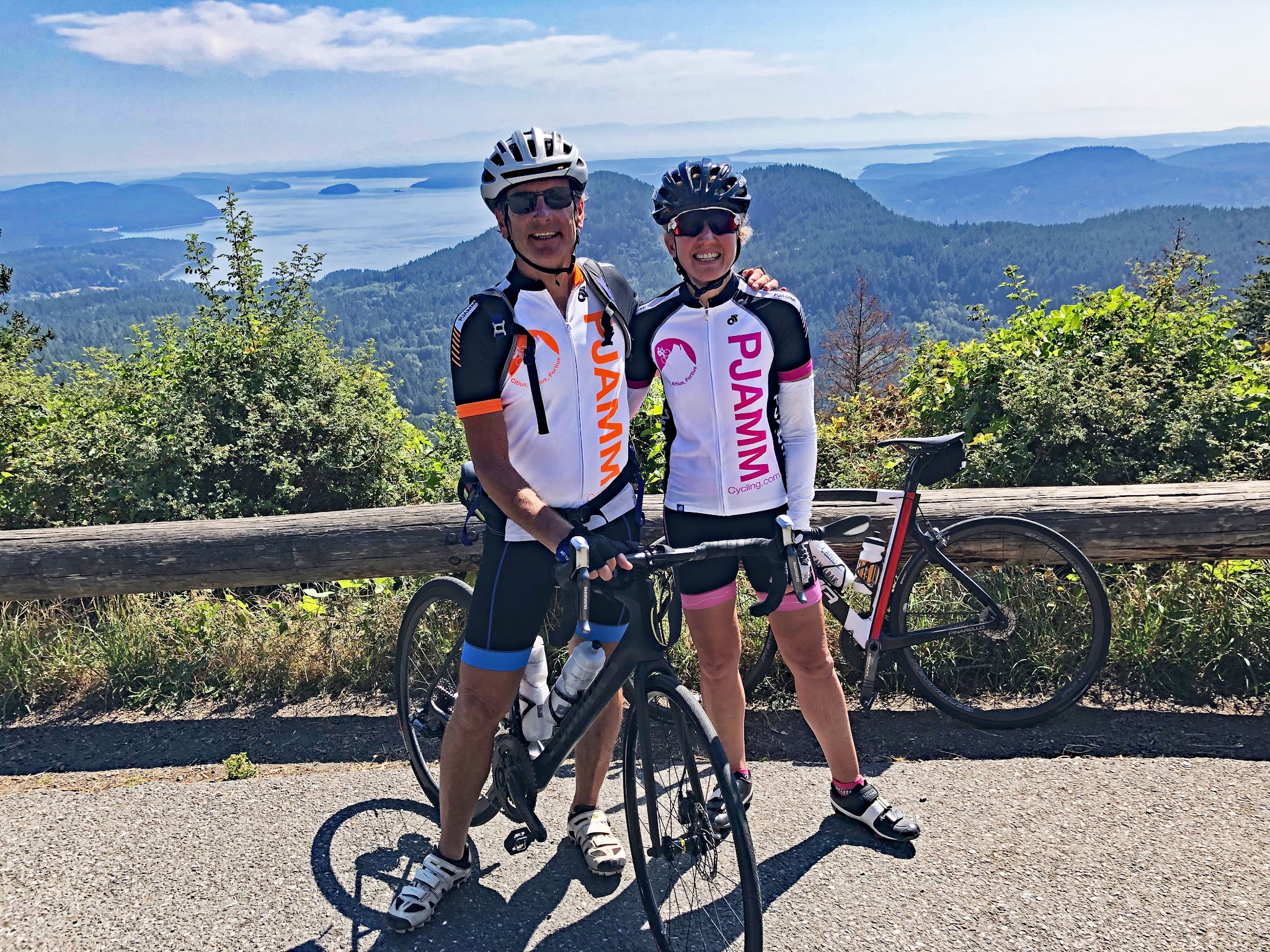 two PJAMM Cyclists stand with bikes at halfway point of route