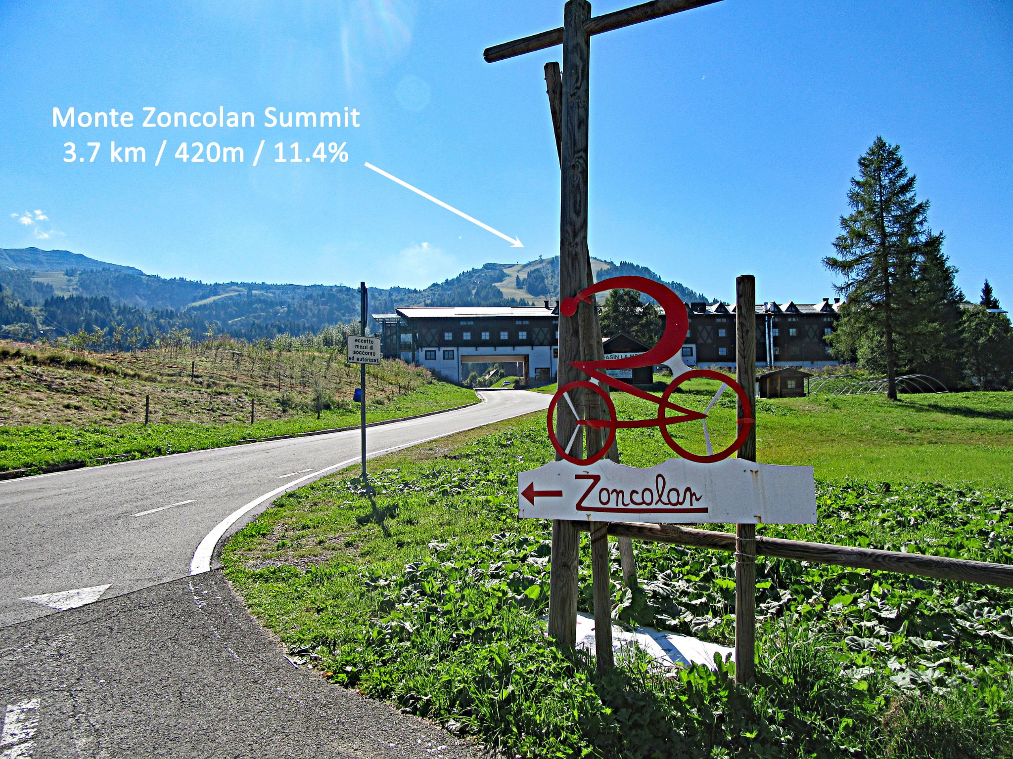 Cycling Monte Zoncolan from Sutrio - Hotel Enzo Moro, a drive-through building you will pass as you head toward the Monte Zoncolan summit in the distance